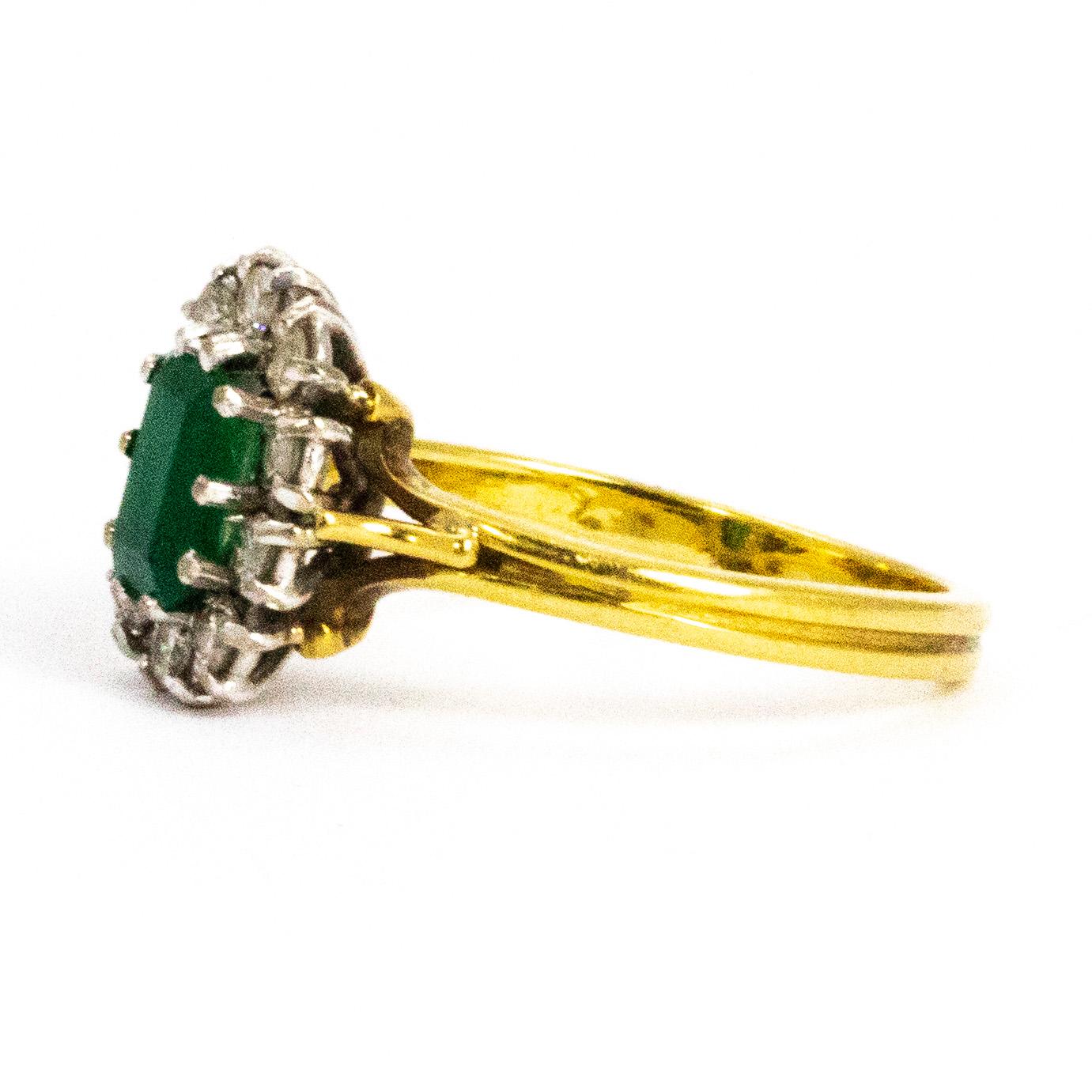 This classic cluster ring has a gorgeous deep green emerald cut emerald as the main attraction. Around the 50pt emerald sits a halo of gorgeous sparkling brilliant cut  diamonds measuring a total of 45 pts. All the stones are set in platinum. 

Ring