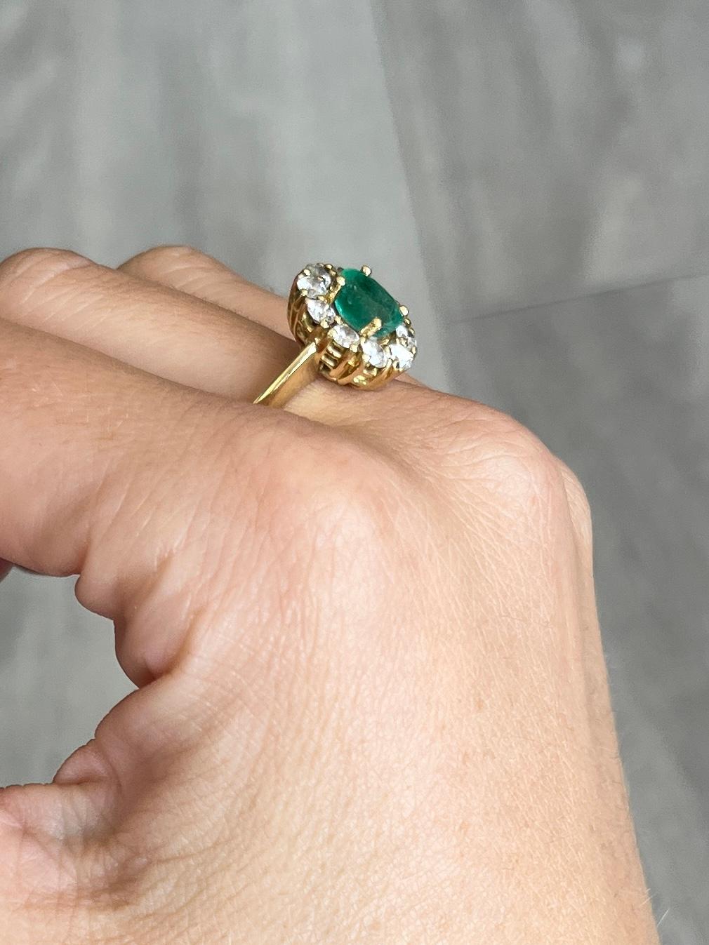 This stunning cluster boasts a 75pt emerald at the centre of it. Surrounding the beautiful green stone are diamonds totalling 50pts. All modelled in 18carat gold. 

Ring Size: N or 6 3/4 
Cluster Dimensions: 13x11mm

Weight: 6.7g