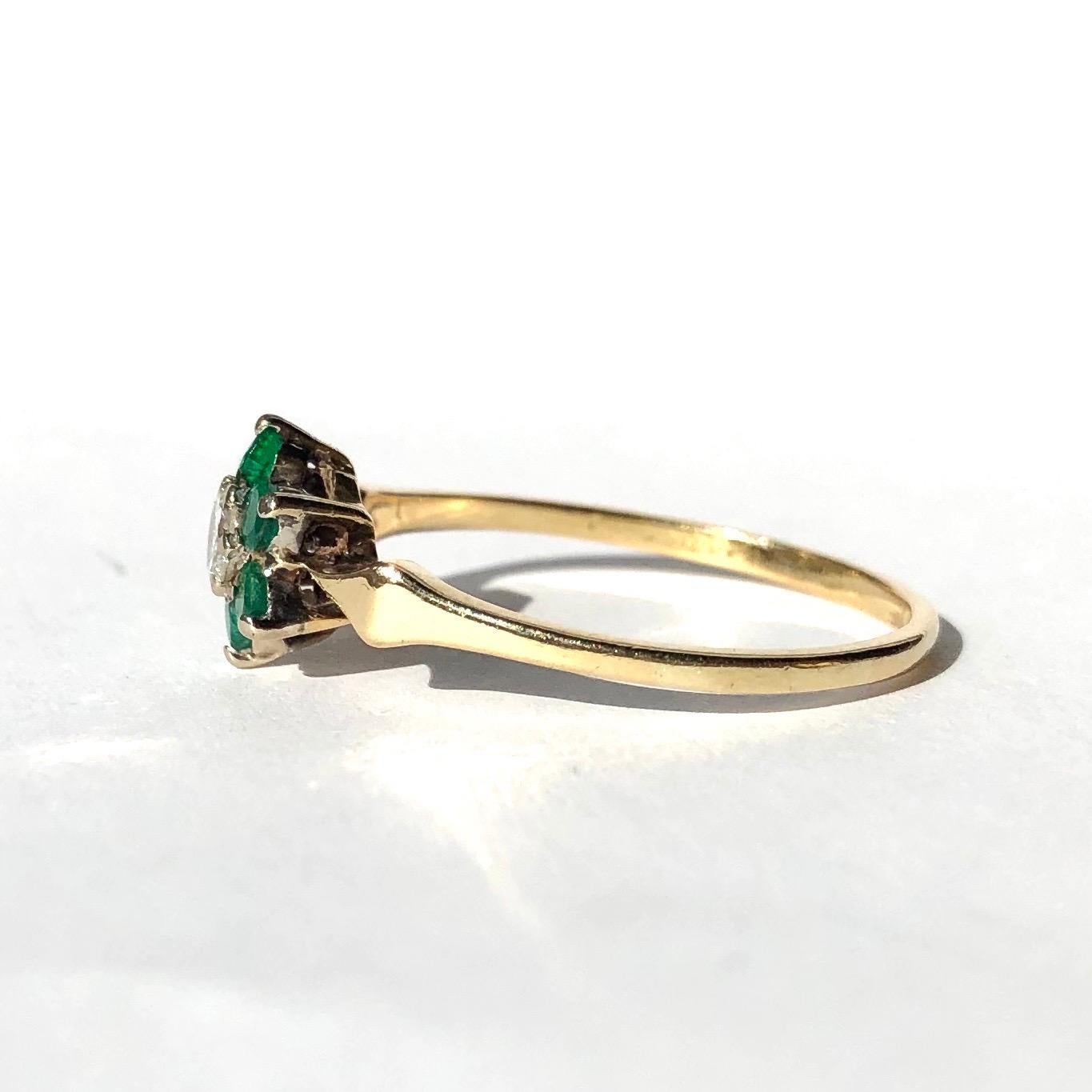 This gorgeous cluster is made up of six bright green emerald measuring 5pts each which encircle a bright sparkling 25pt diamond. The shoulders are modelled into delicate points which hold the cluster. 

Ring Size: R 1/2 or 9
Cluster Diameter: