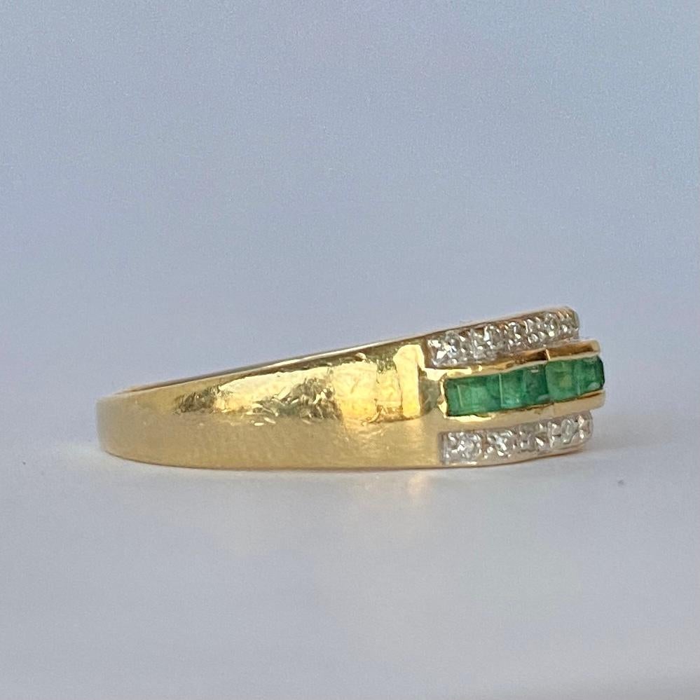 The square cut emeralds in this ring are beautiful and bright and measure 5pts each. Either side of the row of emeralds which are set in a scalloped setting are two rows of diamonds. Each row total approx 10pts of diamonds. The ring is modelled in