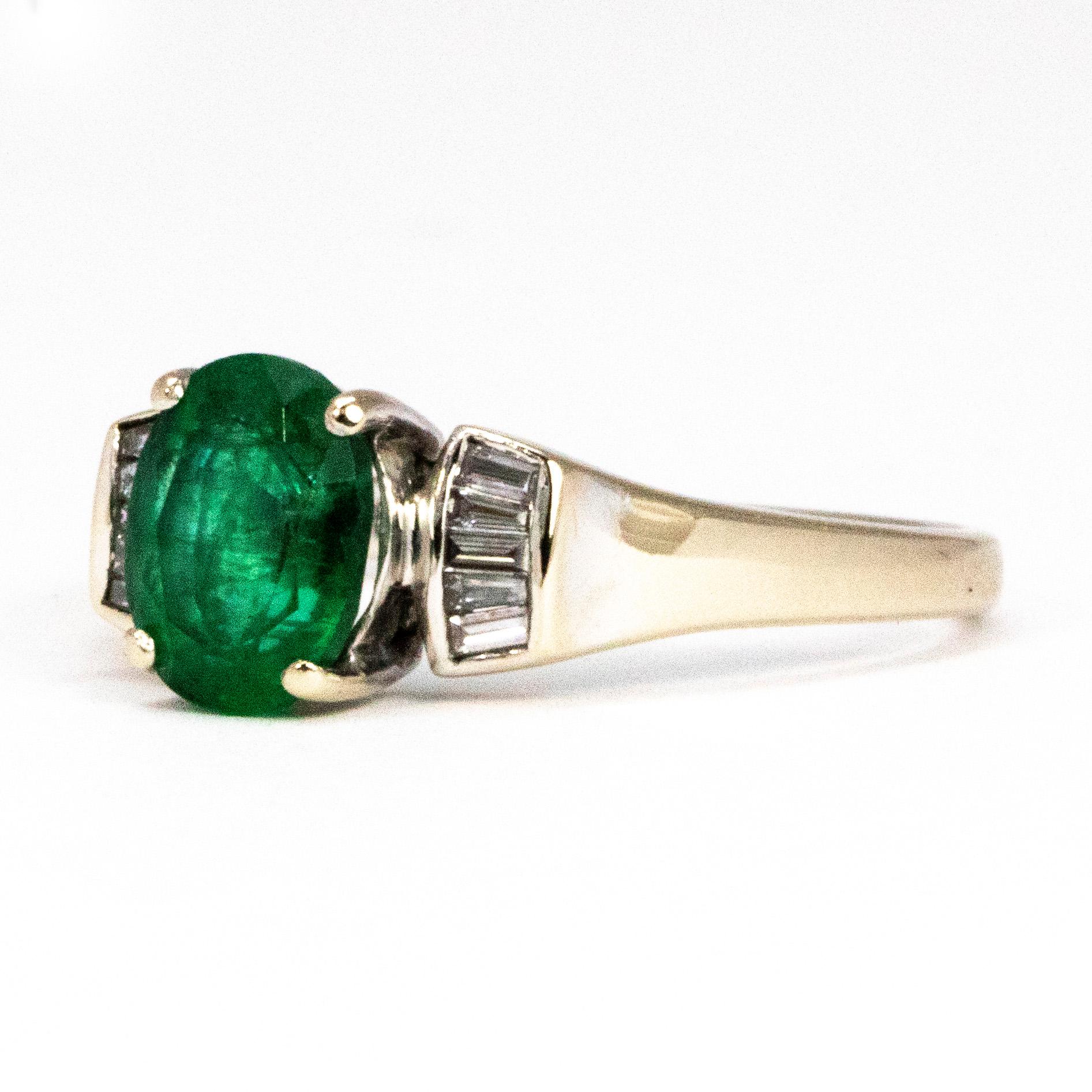 This stunning bright green emerald is an oval shape and measures approximately 1.25carats. The diamonds that sit horizontally either side of the centre stone are slightly tapered. 

Ring Size: P or 7 1/2 
Widest Point: 7.5
