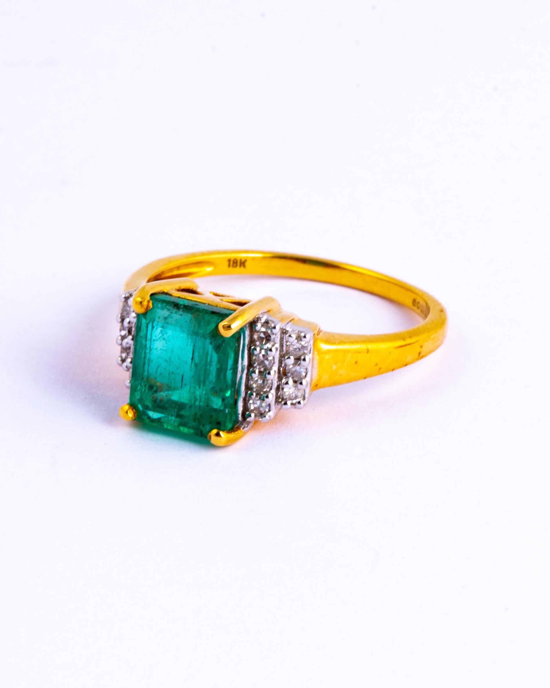 The bright emerald in this ring measures approx 1.8carat and the diamonds in both the shoulders total approx 25pts. The ring is modelled in bright yellow 18ct gold and features a beautiful open gallery. 

Ring Size: N 1/2 or 7 
Width: 8mm
Height Off