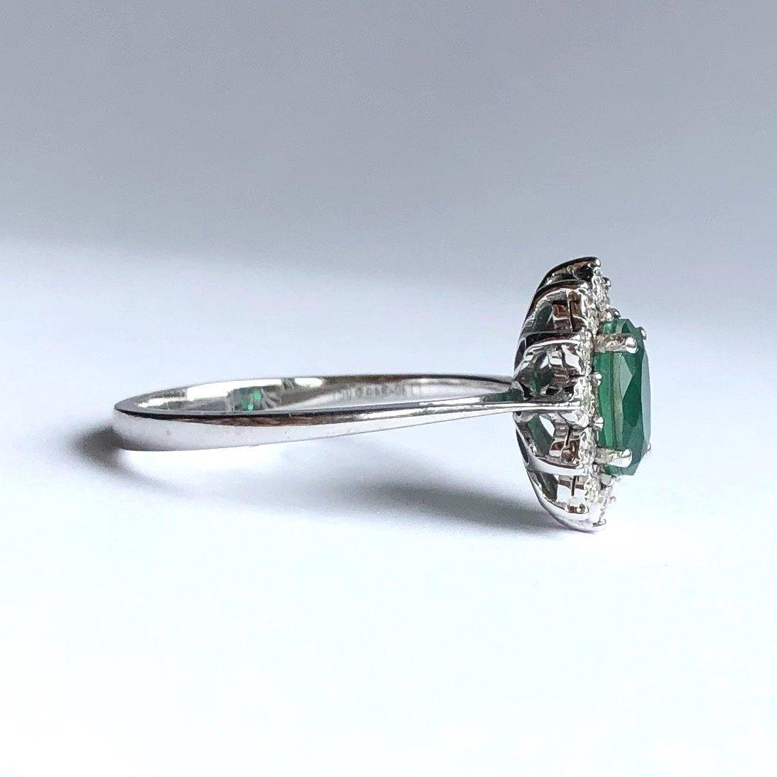 This classic style cluster ring holds a gorgeous bright green emerald at the centre of a diamond halo. The diamonds total approximately 15pts and are set in great illusion settings. The emerald measures 1ct.

Ring Size: O 1/2 or 7 1/4 
Cluster
