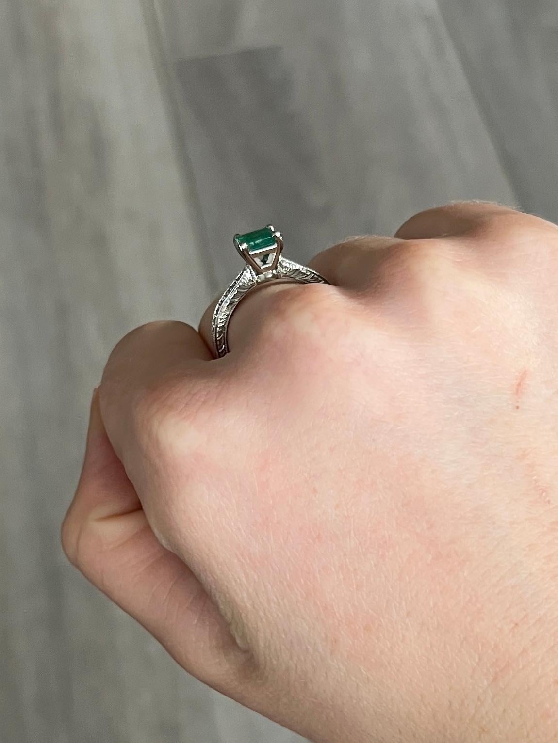 The Emerald in this ring measures 1ct and is a great colour. The total diamond weight of the shoulders is 28pts. The ring is modelled out of 18ct white gold and the band is engraved with beautiful detail all the way around. 

Ring Size: M or 6