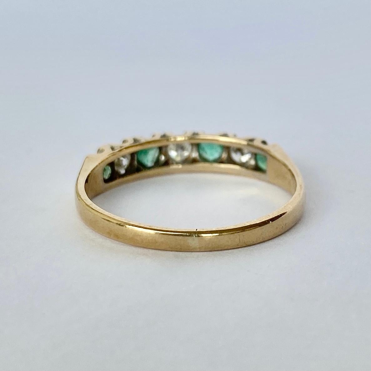 The emeralds in this ring are beautiful and bright and measure 8pts each. In between the gorgeous green stones are diamonds also measuring 8pts each. The ring is modelled in 9carat gold and hallmarked Birmingham 1973.

Ring Size: P or 7 3/4 
Band