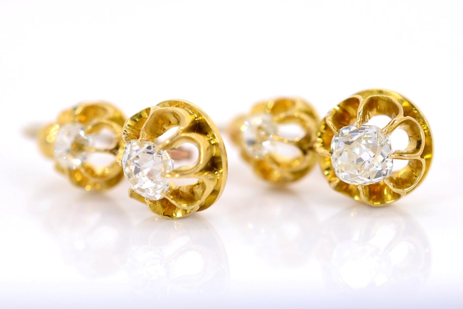 The Victorian-style circa 1950s 18KT yellow gold earrings beautifully flaunt four Old Cushion cut Diamonds.  The shimmering Cushions weigh 1.40 carat and are of sparkling H/I color - VS clarity.   The open claw design baskets showcase the diamonds