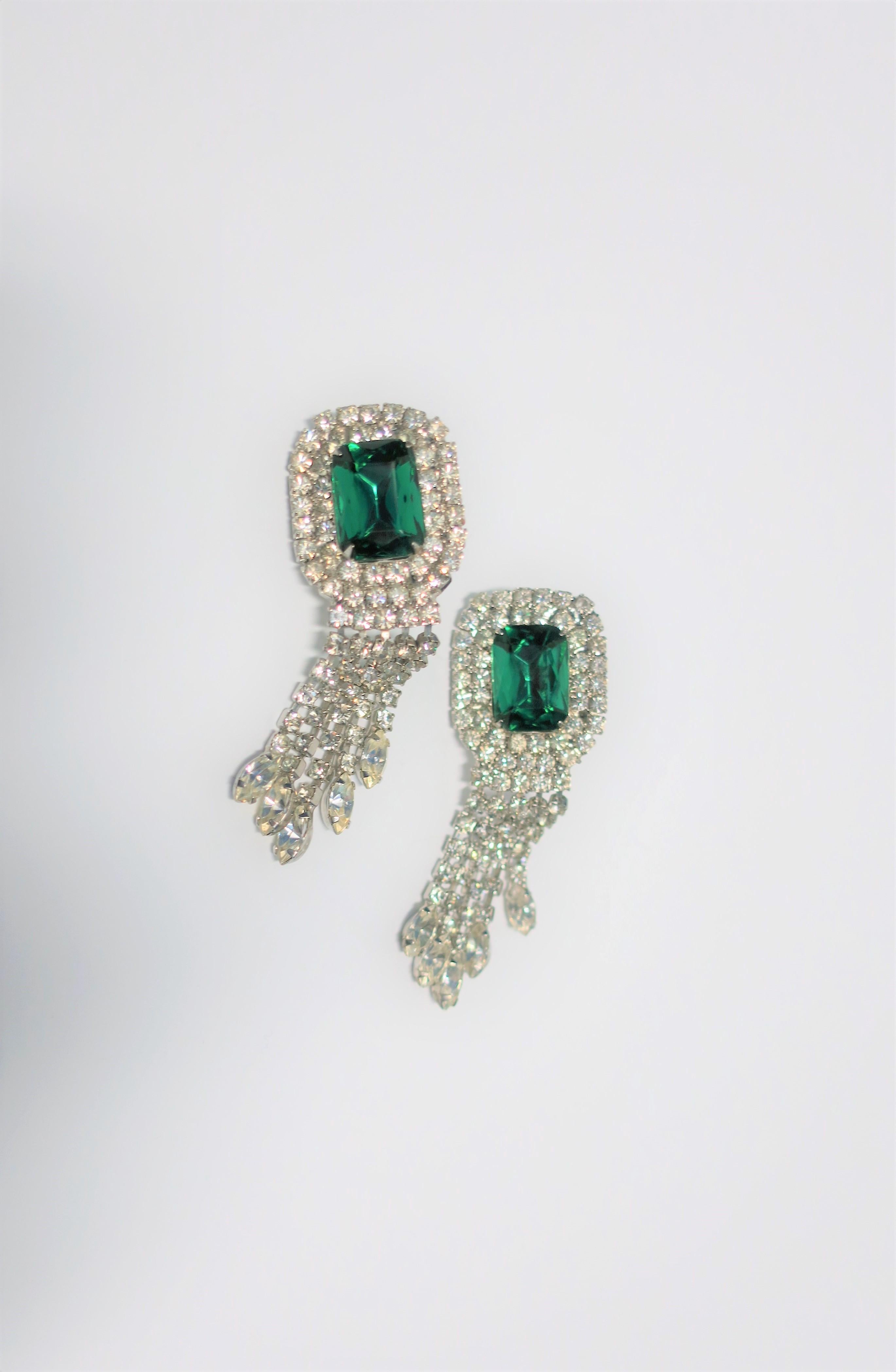 A beautiful pair of vintage clip-on green emerald and diamond-esque rhinestone costume jewelry earrings with tassel-like design. Measurements: 1