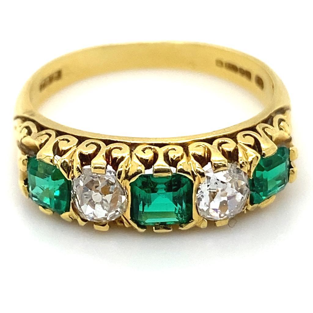 A vintage emerald and diamond five stone 18 karat yellow gold engagement ring.

A beautiful emerald and diamond set five stone ring, the alternating Old European cut diamond and emerald cut emeralds are claw set in an original handmade carved mount