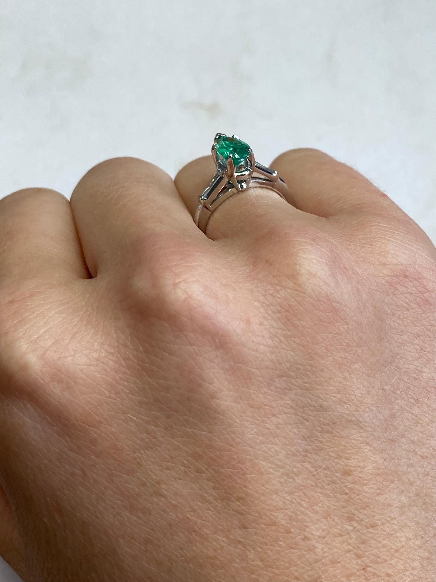 The Pear shaped Emerald in this ring measures 75ct and is a great colour. Either side sit a tapered baguette diamond measuring 10pts per shoulder. The ring is modelled out of platinum.  

Ring Size: J 1/2 or 5
Height Off Finger: 8mm

Weight: 4.1g