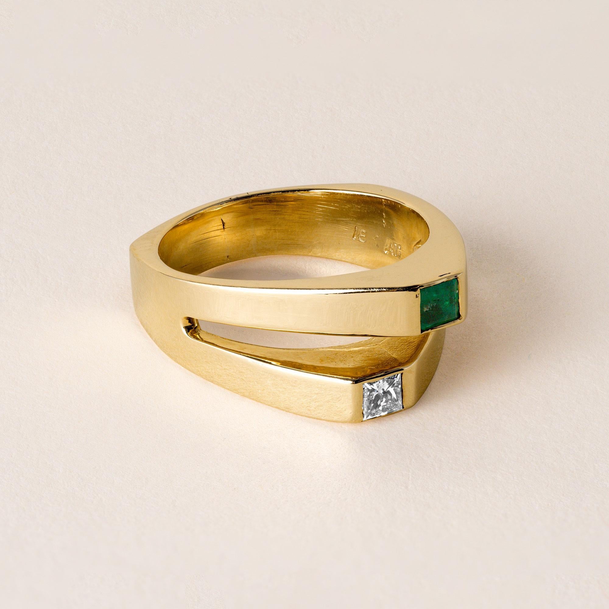 Circa 1980
18K vintage toi et moi ring (you and me in French) features a
~0.12 carat bright green emerald
and ~0.15 carat diamond princess cut
F-G SI1-Si2
Each bezel set in their independent bands that marry together 3/4s
of the way down the Euro