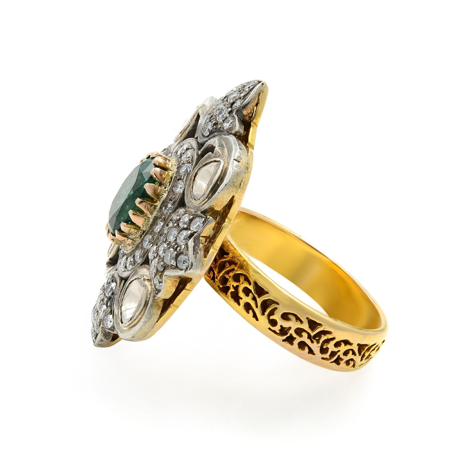 From the 1920s-30s, this elegant oval-shaped emerald is centered with sparkling white smaller diamonds set amidst decoratively. This fabulous Art Deco ring is a rare and ravishing beauty. The top of the ring is 1 inch long. Currently, the ring size