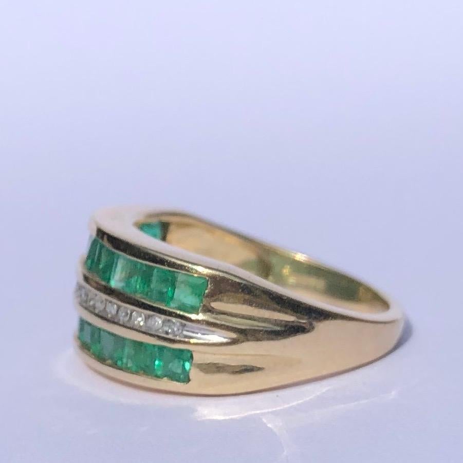 This gorgeous ring holds three rows of gorgeous stones. Two of these rows hold 2pt square cut emeralds which are so bright and pretty, in-between these rows sits a row of round cut diamond points. Modelled in 9ct gold and made in Birmingham,