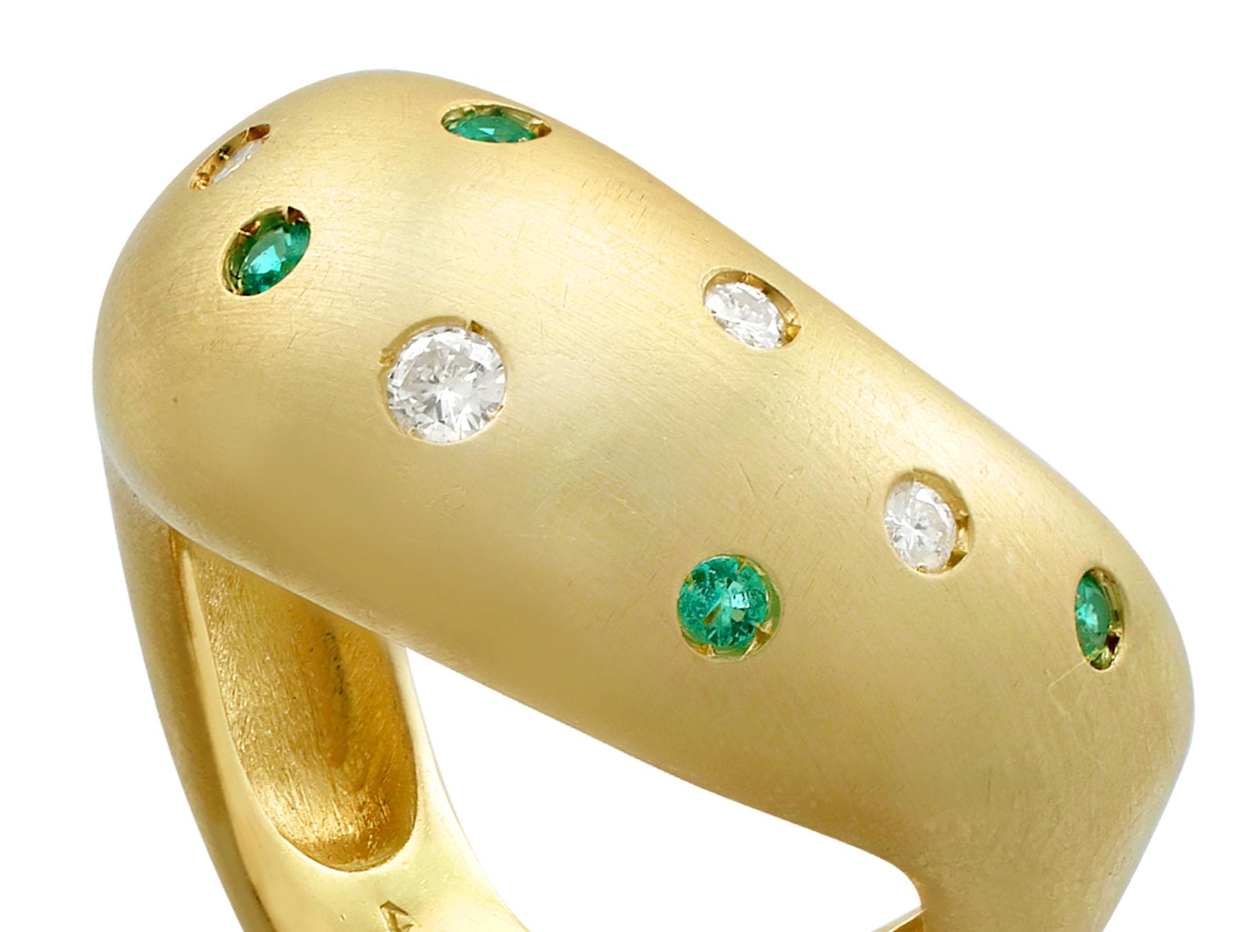 An impressive vintage 1960s 0.13 carat emerald and 0.15 carat diamond, 18 karat yellow gold dress ring; part of our diverse vintage jewelry and estate jewelry collections.

This fine and impressive chunky gold ring with gemstones has been crafted in