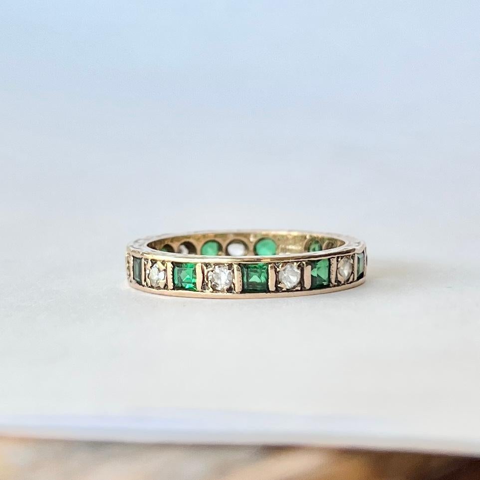 The emeralds set within this 9ct gold band are square cut and measure 5pts each and in-between these stone are 4pt white sapphires. Emerald total approx 55pts. Fully hallmarked Birmingham 1972.

Ring Size: K 1/2 or 5 1/2 
Band Width: 3mm 

Weight: