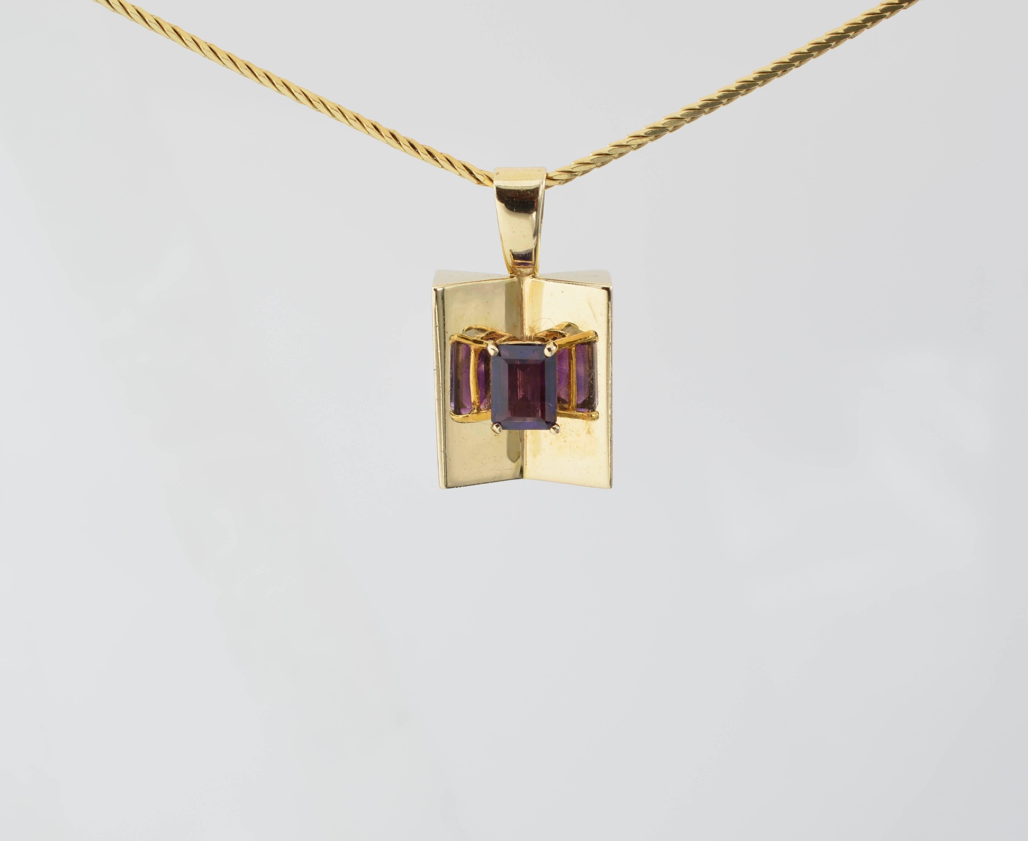 1970's vintage amethyst mirror pendant. Three reflections of the center stone create an optical illusion of added dimensions. Very popular in the 1970's. A substantial piece of 14K yellow gold with an 18.5 inch chain. 