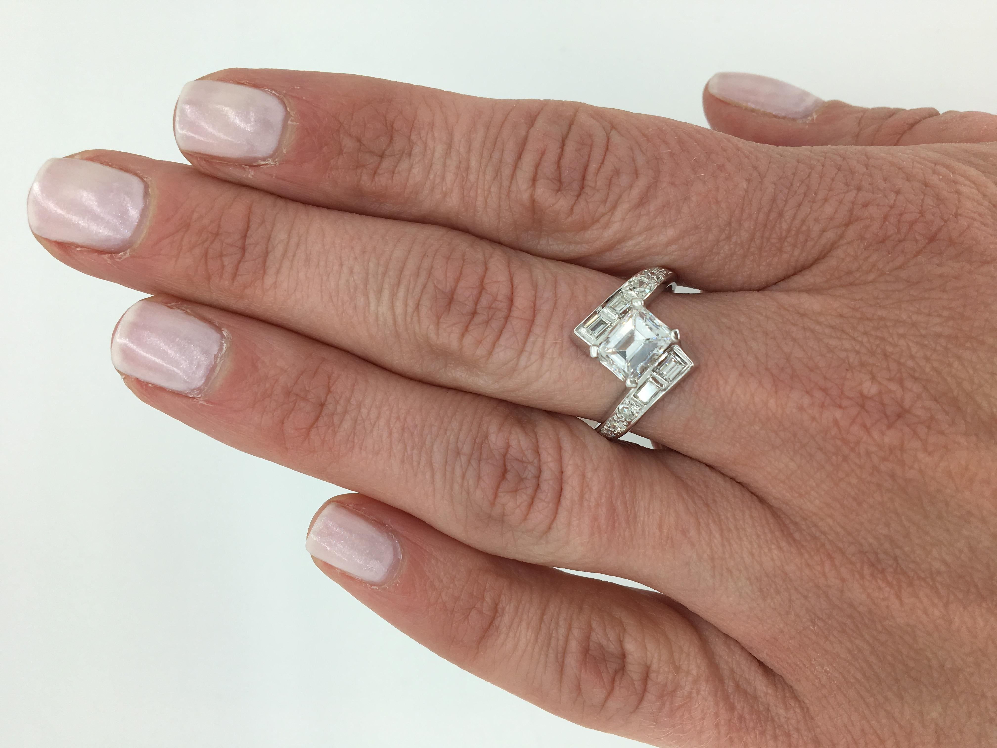 Unique Emerald Cut bypass style diamond ring crafted in 18K white gold.

Center Diamond Carat Weight: Approximately 1.05CT
Center Diamond Cut: Emerald Cut
Center Diamond Color: G
Center Diamond Clarity: SI2
Total Diamond Carat Weight: Approximately