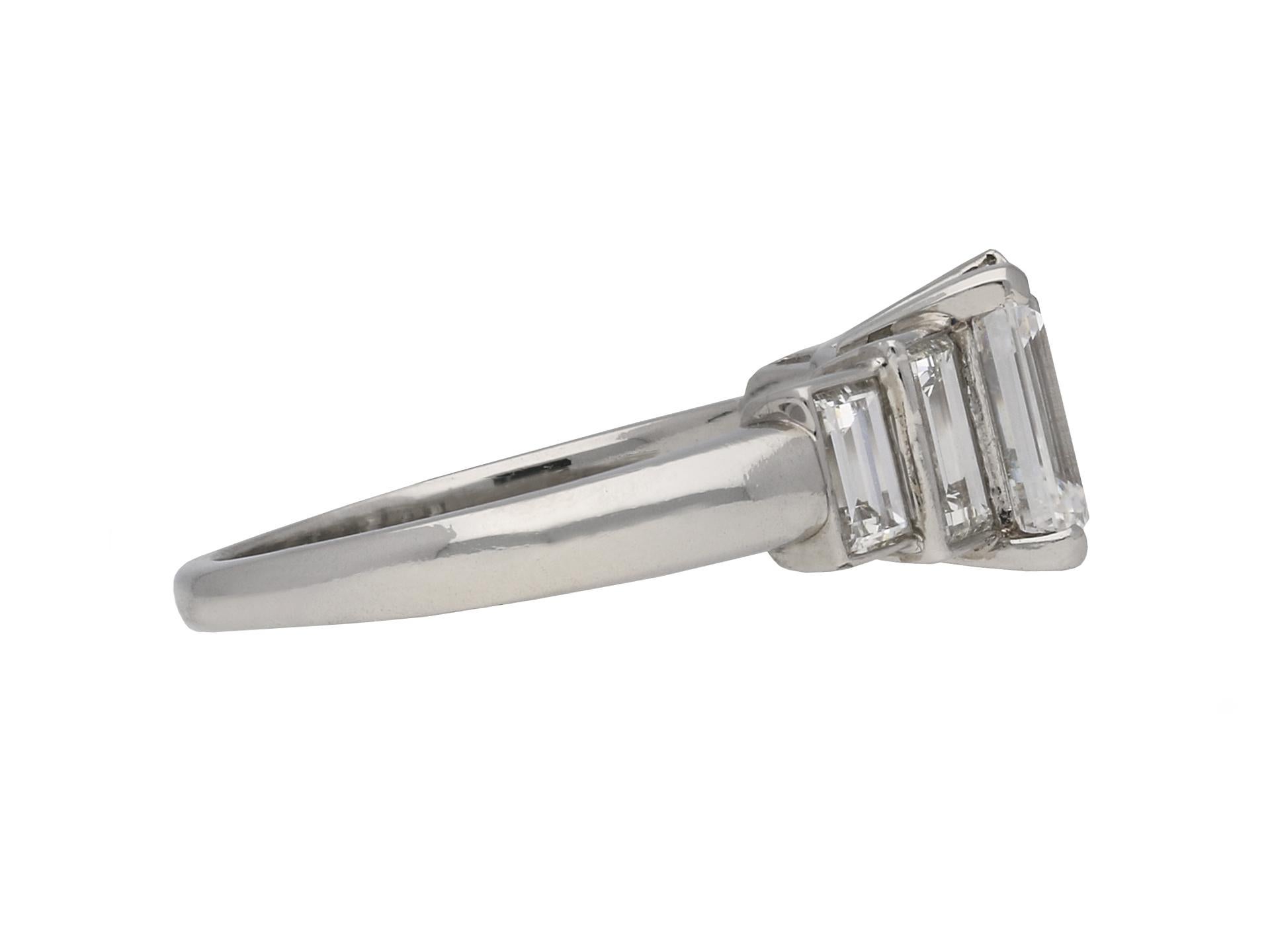 Vintage emerald-cut diamond flanked solitaire ring. Set to centre with a rectangular emerald-cut diamond, D colour, internally flawless clarity with an approximate weight of 1.52 carats in an open back claw setting, flanked by two rectangular