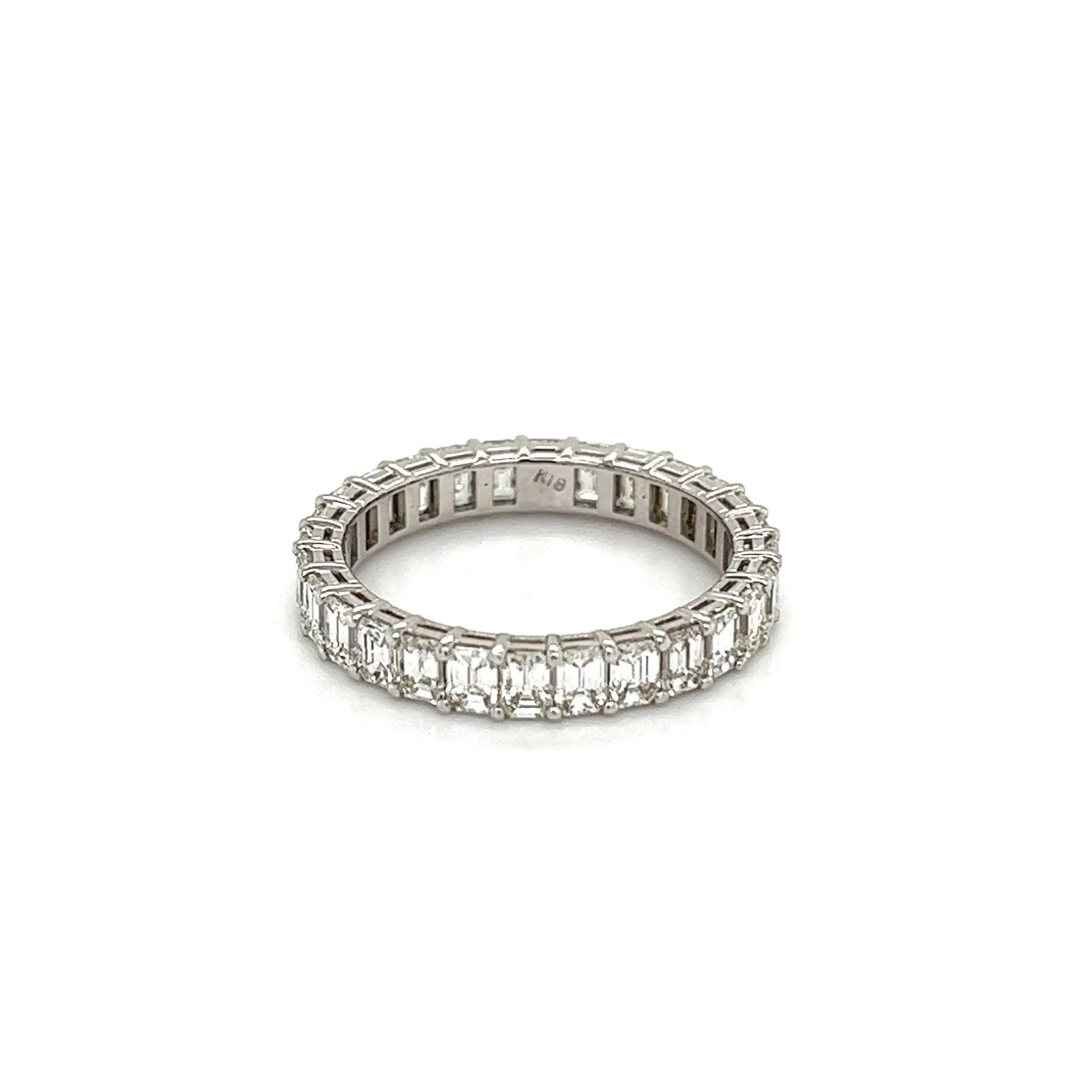 Simply Beautiful! Finely detailed Diamond Eternity Gold Band Ring. Hand set with securely nestled 28 Emerald Cut Diamonds, weighing approx. 2.70tcw; G-VS Quality. Hand crafted 18K White Gold mounting. Ideal worn alone or as an alternative Engagement