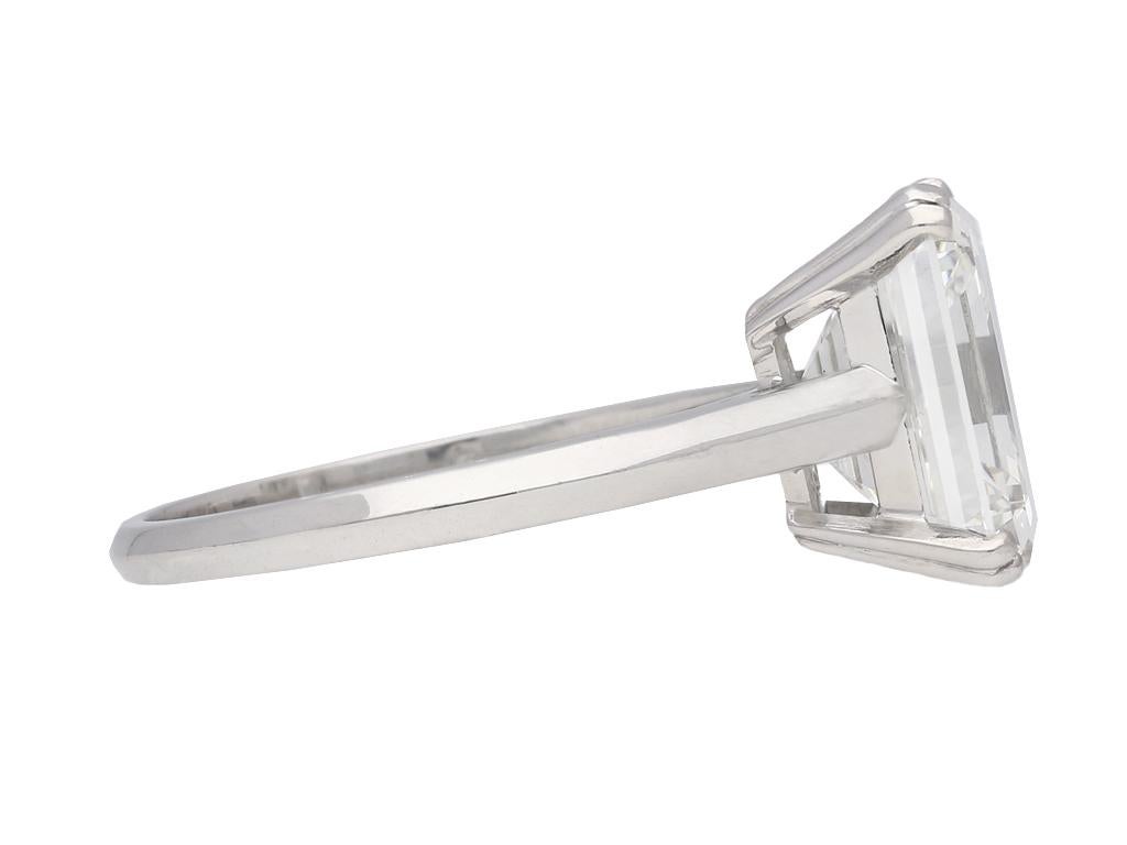 Vintage emerald-cut diamond solitaire diamond ring. Set with a rectangular emerald-cut diamond, H colour, VS1 clarity with an approximate weight of 5.13 carats in an open back claw setting, to an impressive solitaire design, fancy split claws,
