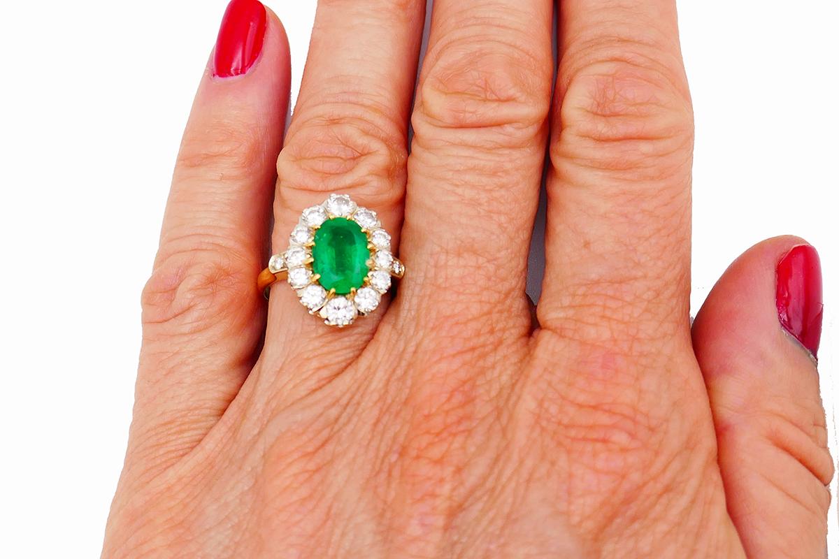 Classy and timeless ring made of 14k yellow gold and featuring 1.78-carat natural emerald in a halo of thirteen round brilliant cut diamonds (H-I color, VS clarity, 0.95 carat total weight). The diamonds are set in white gold.
Measurements: 3/4