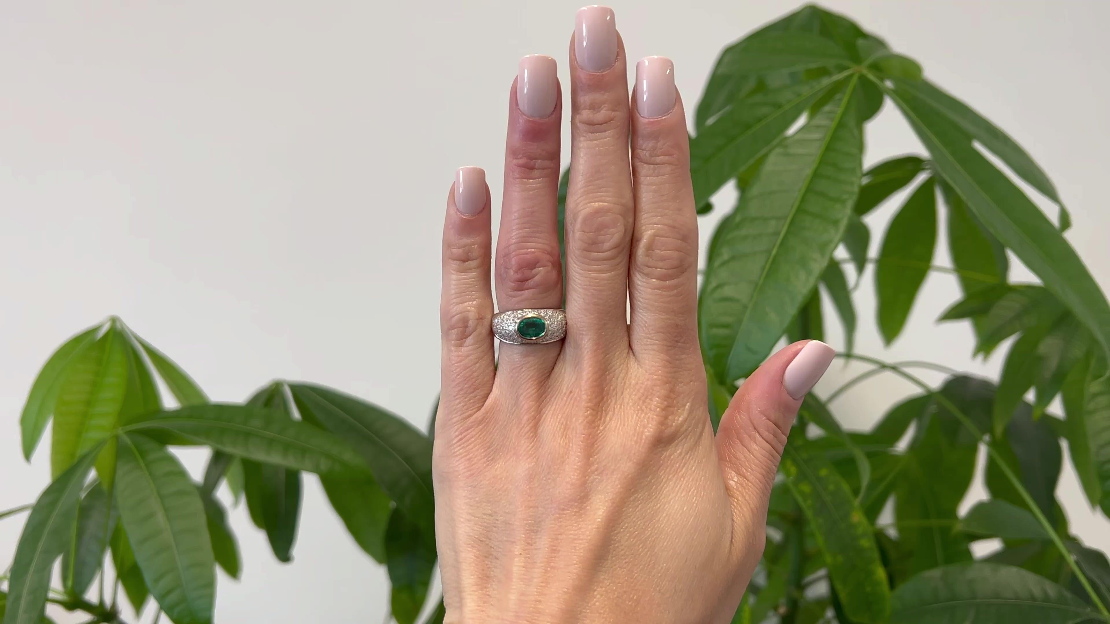 One Vintage Emerald Diamond 18k White Gold Ring. Featuring one oval mixed cut emerald weighing approximately 0.75 carat. Accented by 54 round brilliant cut diamonds with a total weight of approximately 1.50 carats, graded F color, VS clarity.