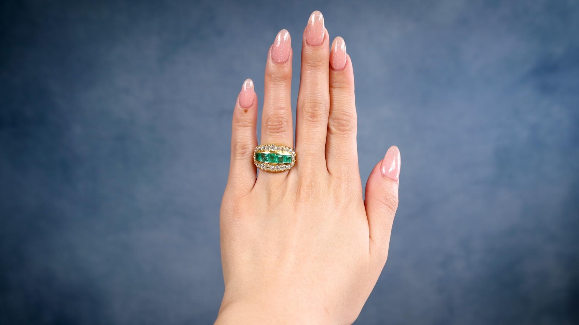 One Vintage Emerald Diamond 18k Yellow Gold Ring. Featuring five square step cut emeralds with a total weight of approximately 1.50 carats. Accented by 24 old European cut diamonds with a total weight of approximately 1.90 carats, graded colorless,