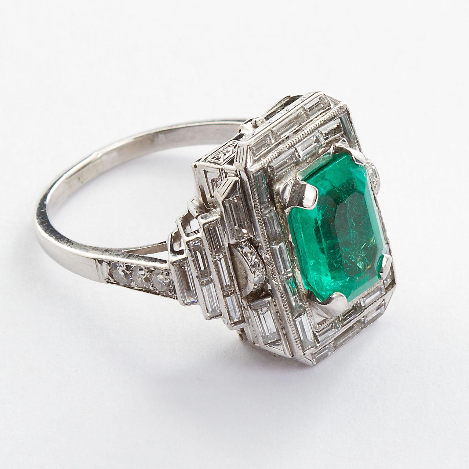 An Art Deco inspired platinum vintage ring set with an approx. 4.00 carat octagon emerald and set with surrounding baguette cut diamonds. Ring size 7 (can be resized down to 4).

No. TMWJ-8318