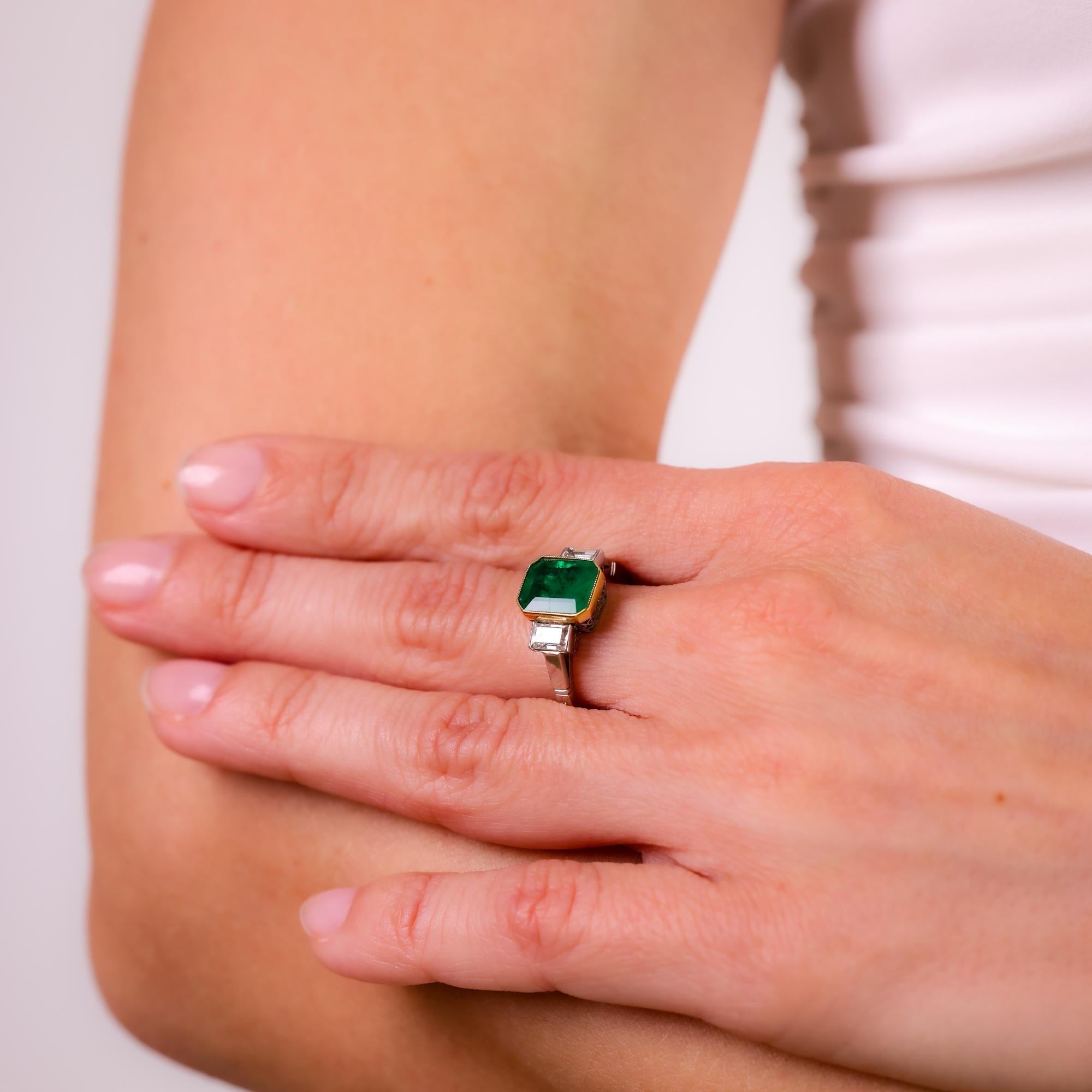This vintage 1990s ring showcases a vibrant 1.59 carat emerald, accented by baguette diamonds, elegantly set in platinum and 18k yellow gold for a timeless look.

Center stone: Emerald cut emerald
Weight: 1.59 carats
Accent stone: two baguette