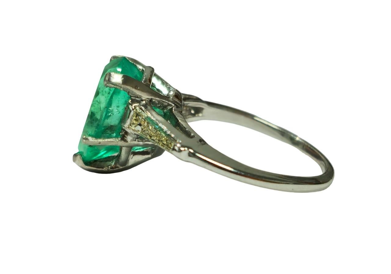Immerse yourself in timeless luxury with our exquisite Unisex Diamond, Emerald, and Platinum Ring. Crafted from solid platinum, this one-of-a-kind vintage jewelry piece features a stunning 4.50 carat pear-shaped Colombian emerald set in prongs,