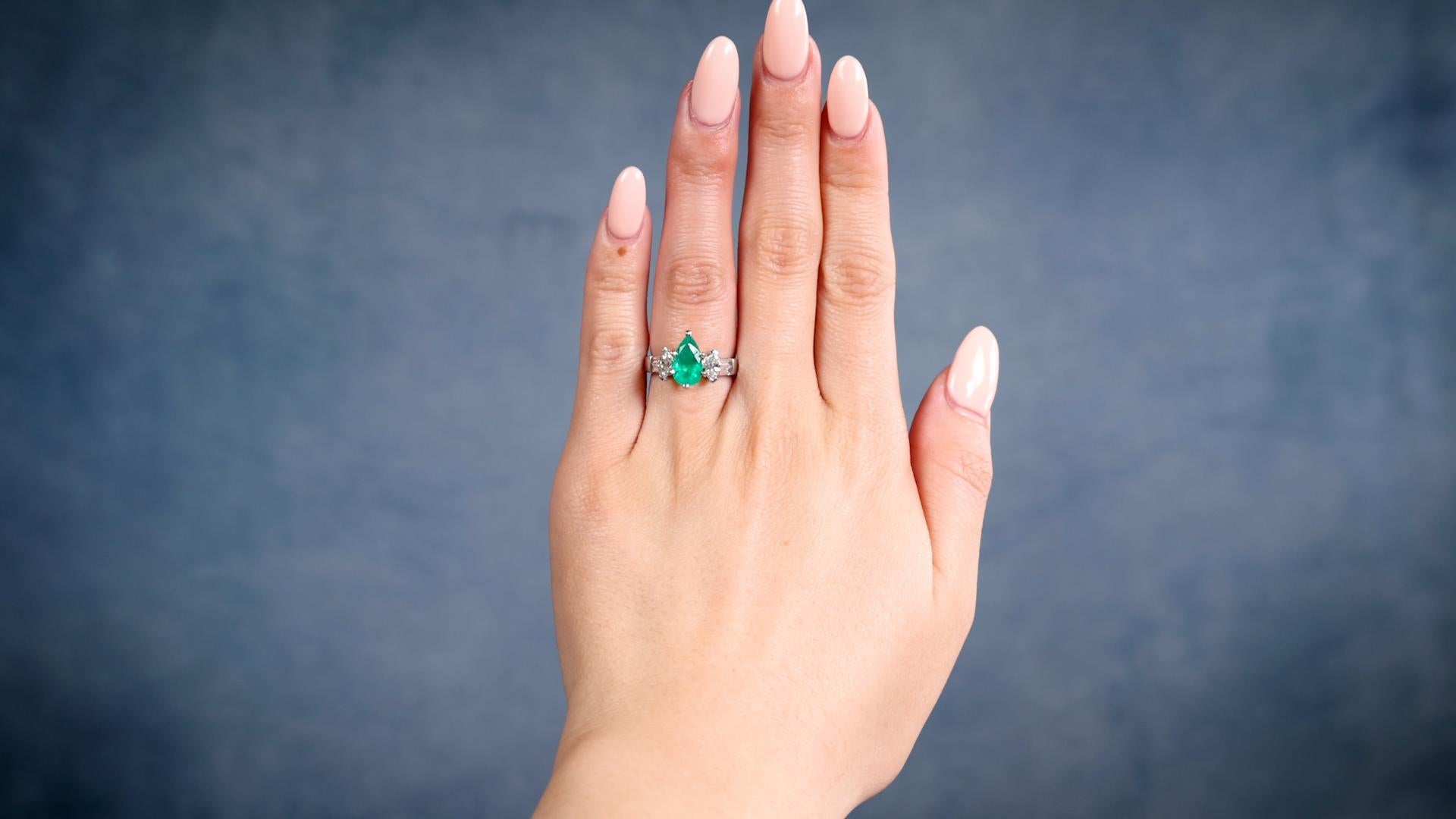 One Vintage Emerald Diamond Platinum Ring. Featuring one pear brilliant cut emerald weighing approximately 1.00 carat. Accented by two marquise and four baguette cut diamonds with a total weight of 0.65 carat, graded G-H color, VS clarity. Crafted