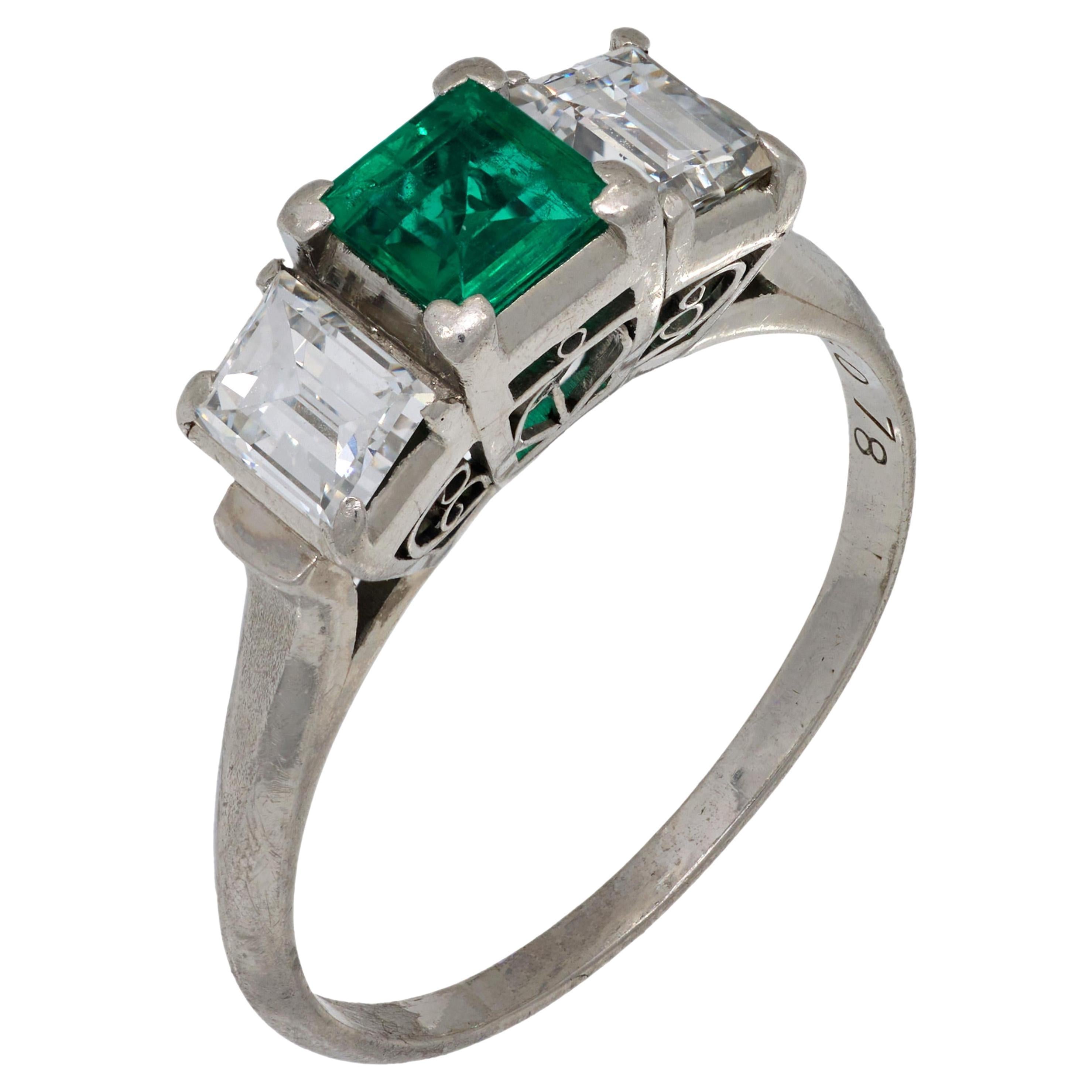 Vintage emerald diamond platinum three stone ring