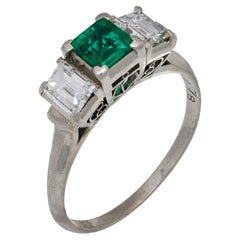 Vintage emerald diamond platinum three stone ring