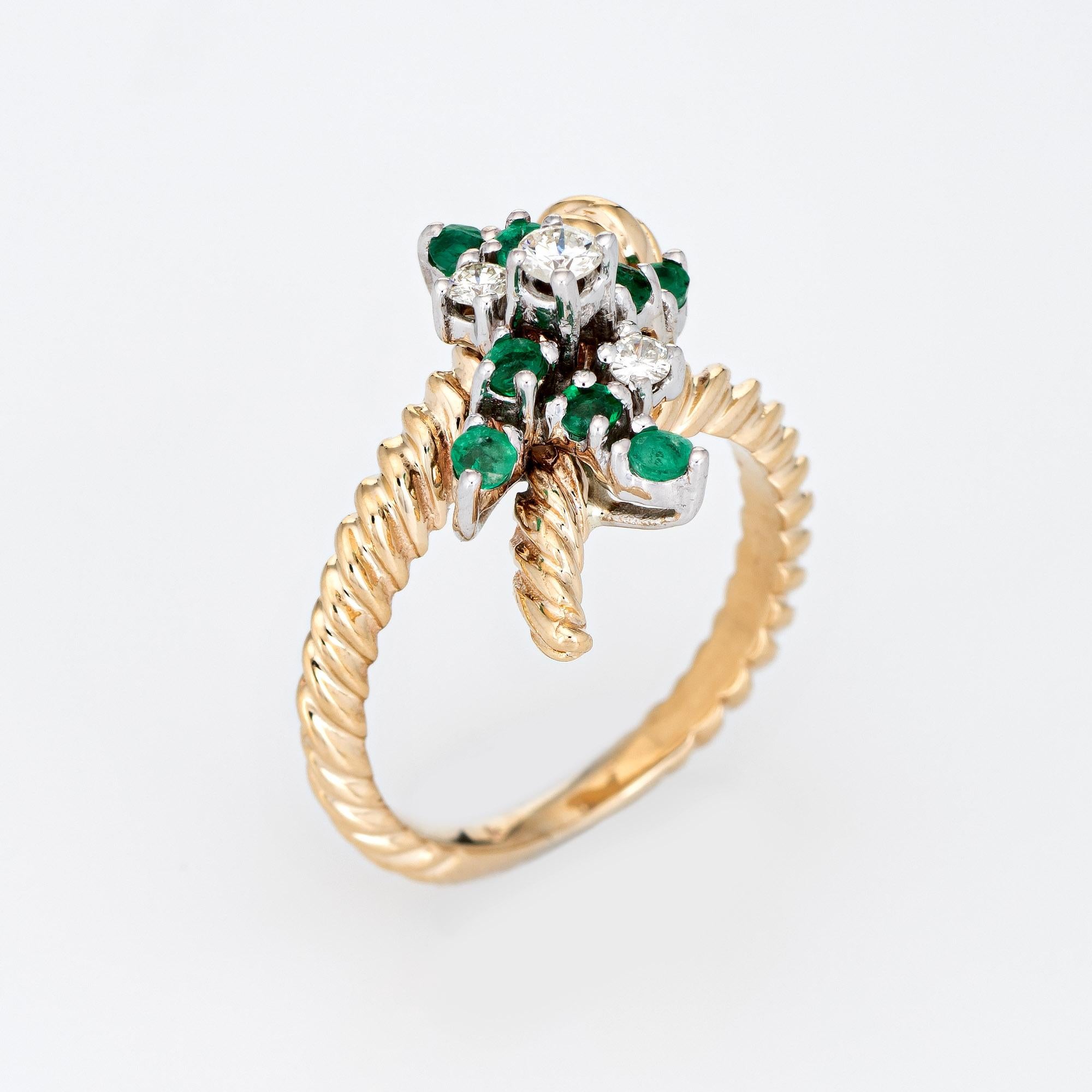 Stylish vintage emerald & diamond cocktail ring (circa 1960s to 1970s) crafted in 14 karat yellow gold. 

3 diamonds total an estimated 0.10 carats (estimated at I-J color and SI1 clarity), accented with 8 emeralds that total an estimated 0.16