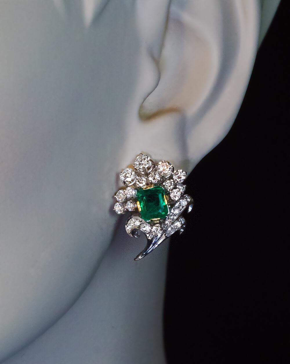 Circa 1950s
The earrings are crafted in 18K white gold (14K gold posts). They are designed as sprays of flowers set with two bluish green emeralds (0.98 ct and 0.91 ct) and high quality bright white diamonds (E-F color, VS1-VS2 clarity).
Total