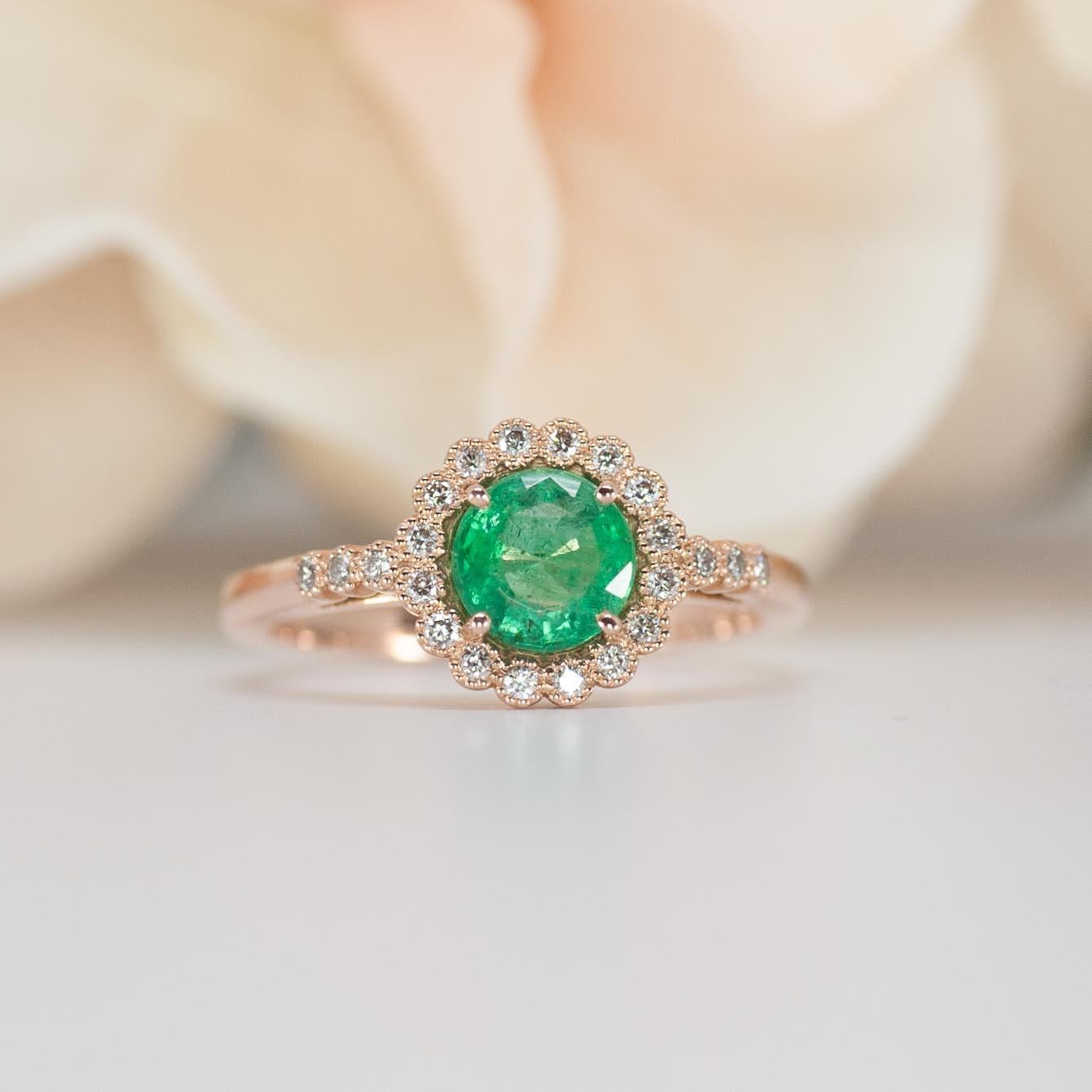 This vintage inspired emerald engagement ring offers a unique design with milgrain detail around the halo and band diamonds. 

♦♦♦Ring Information ♦♦♦

Center Stone:
* Natural Emerald
* Gemstone size: 6 mm Round Cut
* GIA Color & Clarity : Medium