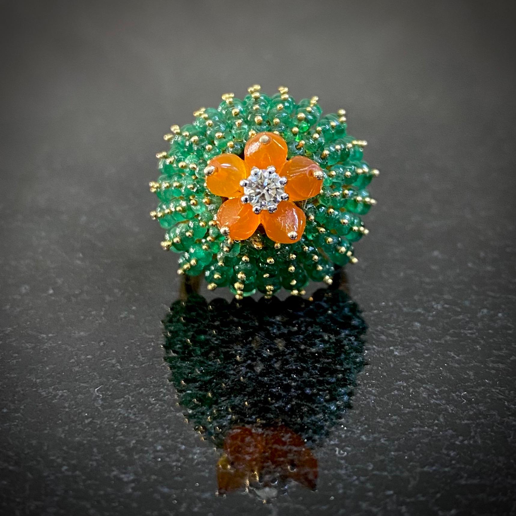 Vintage emerald, fire opal and diamond bombé cactus cocktail ring in 18kt yellow gold, 1990s. Designed in the manner of Cartier’s Cactus ring, this sculptural dome ring makes a bold statement. It is modelled as a stylized cactus, the arms composed