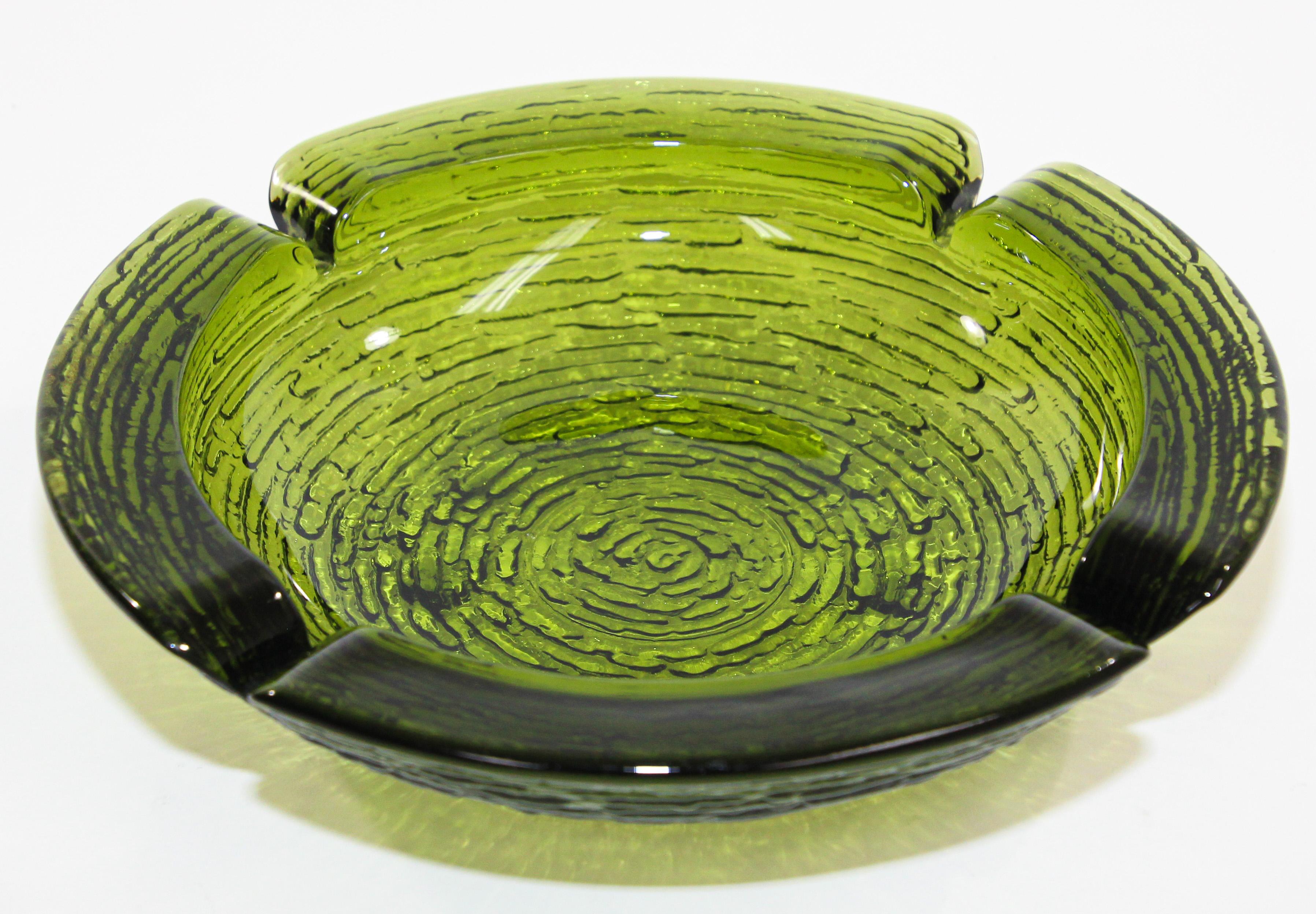 Large vintage Mid-Century Modern emerald green Blenko glass ashtray from the 1950s.
Fabulous Blenko Art Glass ashtray in green with textured bottom. 
This beautiful, green ashtray is a great example of Mid Century Modern Retro style, color, and