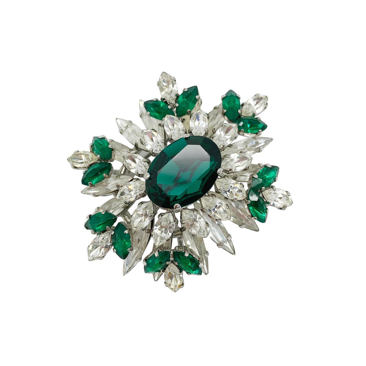 A vintage marquise crystal brooch from the mid century, featuring the most adorable crystals. Emerald glass and white crystals cut in a marquise style are exquisitely layered to create a stylish three-dimensional effect that speak endless opulence