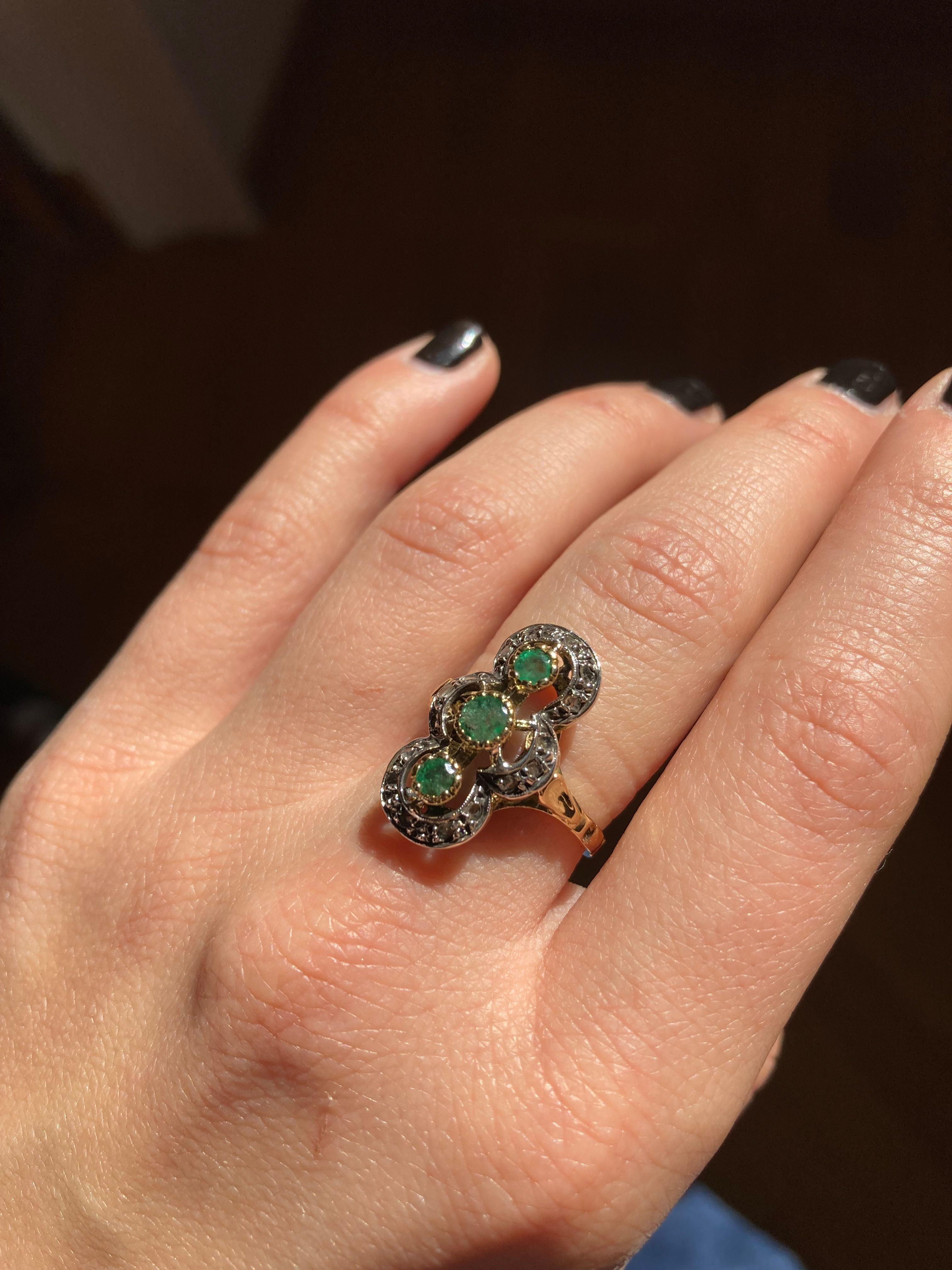 Deco Style Vintage ring made of 18k yellow Gold, three  round-cut, Emeralds . Encircling the Emeralds are a crown of old cut diamonds set in silver creating a captivating design.
Dimension: height 0,82 in. x wide 0,47 in. (cm 2.1 x 2.2cm) 
Ring