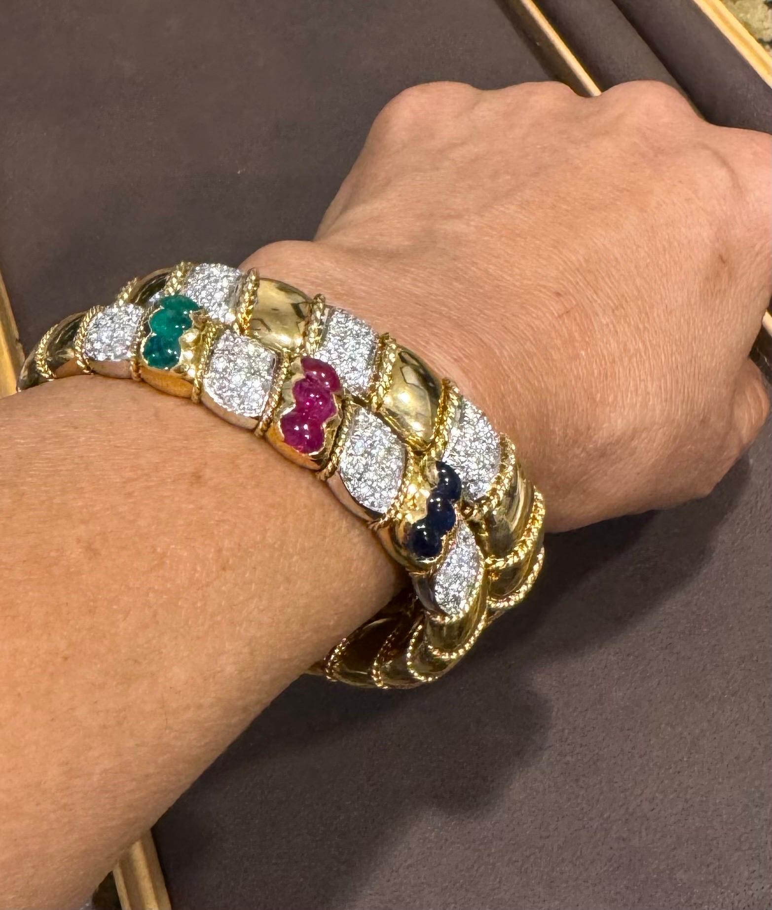 This stunning vintage cuff bangle bracelet features an exquisite combination of precious gemstones and dazzling diamonds. Crafted from 18 karat solid yellow gold, it showcases a total of three carats of diamonds, intricately set in multiple bars.