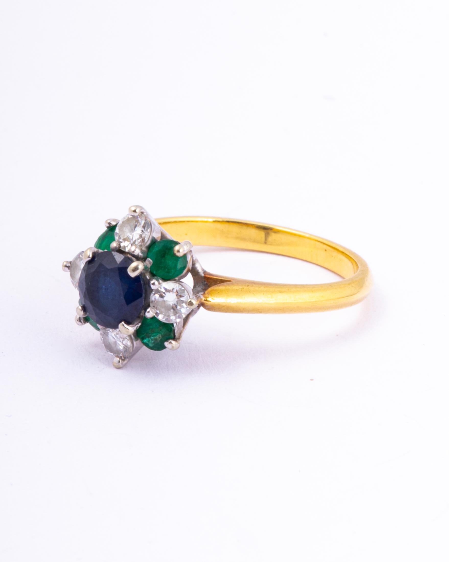 This cluster ring holds a sapphire measuring 50pts and the emeralds total 40pts and the round brilliant cut diamonds total 40pts. The stones are placed up high on an open work gallery, they are also set in platinum. 

Ring Size: J 1/2 or 5 
Height