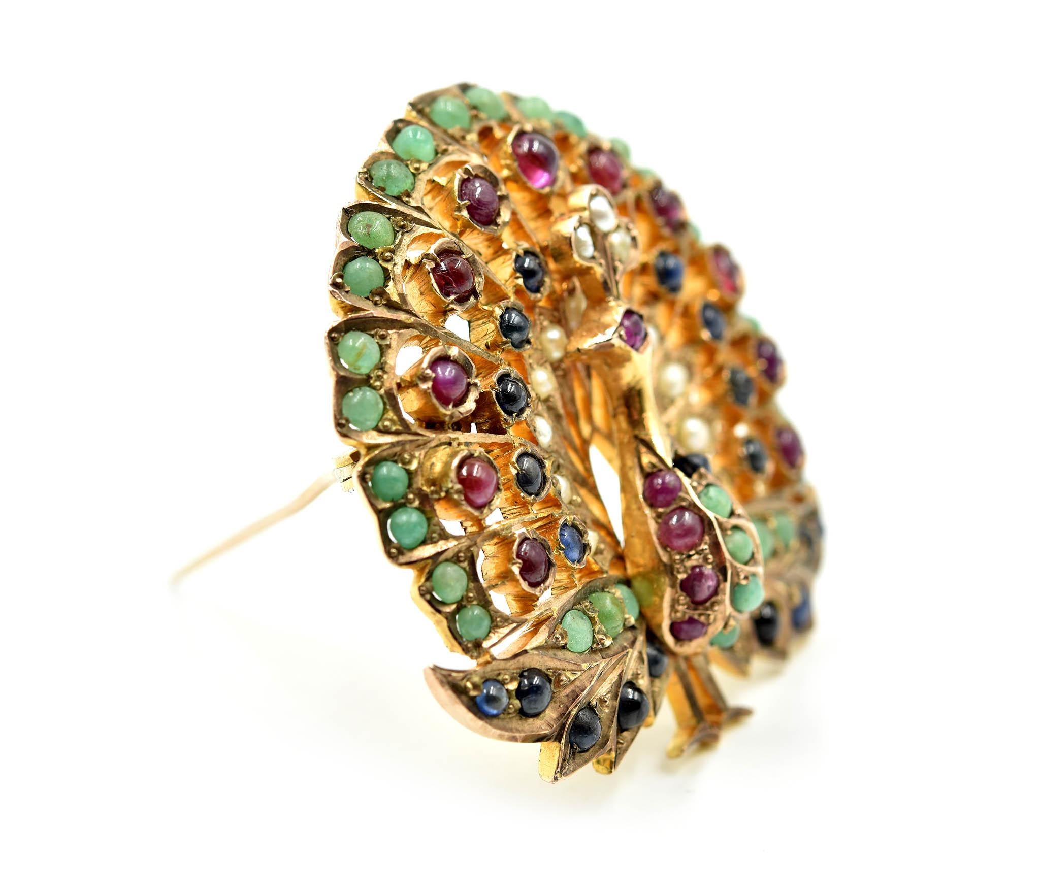 Designer: custom design
Material: 9k yellow gold
Gemstones: emerald, rubies and sapphire unfaceted round stones
Dimensions: pin measures 1 ¾ inches long and 2 inches wide
Weight: 27.03 grams
