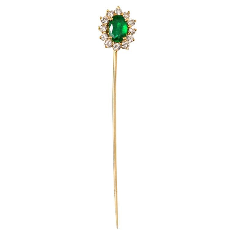 Vintage tie or lapel pin set with an oval emerald centre and a surround of twelve brilliant cut diamonds. Mounted in 18 carat yellow gold. Identical to a ruby and diamond tie pin also in my collection which were made at the same time by the same