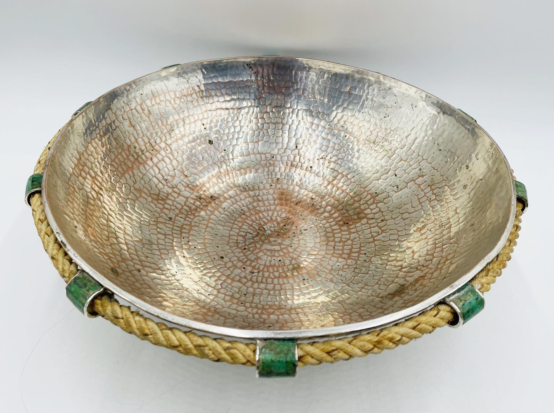 Elevate your home decor with this exquisite Vintage Emilia Castillo Bowl with Rope & Malachite Accents, originating from Mexico in the 1990s.
The piece was made in Taxco mexico by skilled artisans that have been doing this type of work for