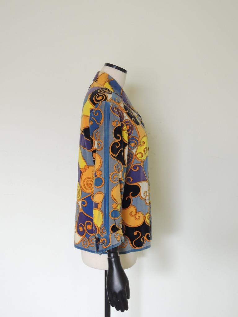 Vintage Emilio Pucci cotton velvet jacket, I believe late 1960s or early 1970s era, with gorgeous vibrant hues of yellow, blue, orange, purple and white. Fold over collar with notch lapels, velvet covered buttons, lined.

Made in Italy.

The jacket