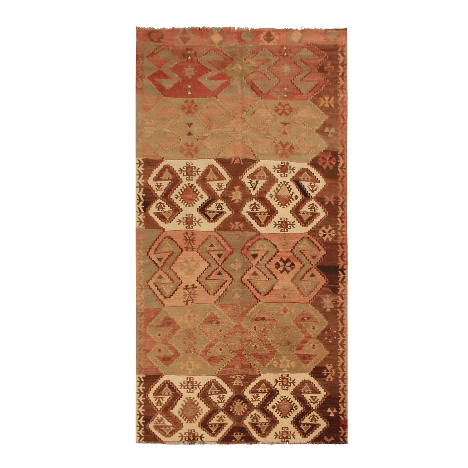 Flat-woven in high-quality wool originating from Turkey between 1940-1950, this vintage Esme Kilim rug enjoys an intriguing marriage of symmetry in pattern with a creative distribution of colorways, engaging the viewer with a very arresting