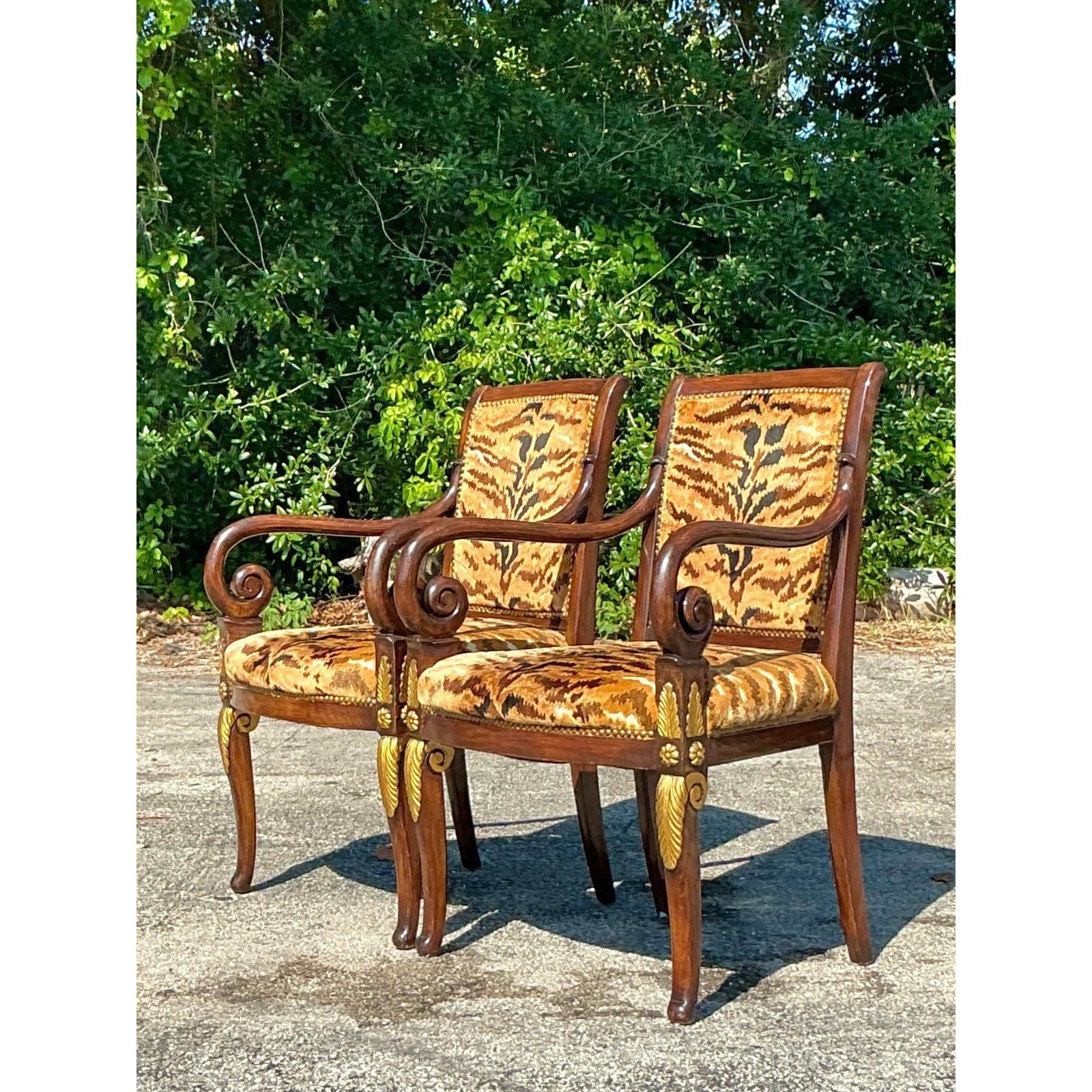 Elevate your interior with this exquisite pair of Vintage Empire-style Fauteuils, featuring iconic Scalamandré tiger velvet upholstery. These statement chairs boast striking neoclassical silhouettes with gracefully scrolled arms, rich wood frames,