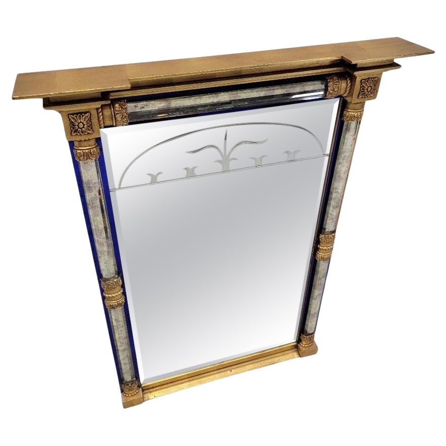 Vintage Empire Federal Style Vergoldeter Wandspiegel mit abgeschrägten Glaskanten und kobaltblauer Verzierung 

Dieser vergoldete Vintage-Wandspiegel im Empire-Federal-Stil zeichnet sich durch aufwändige Schnitzereien und eine atemberaubende
