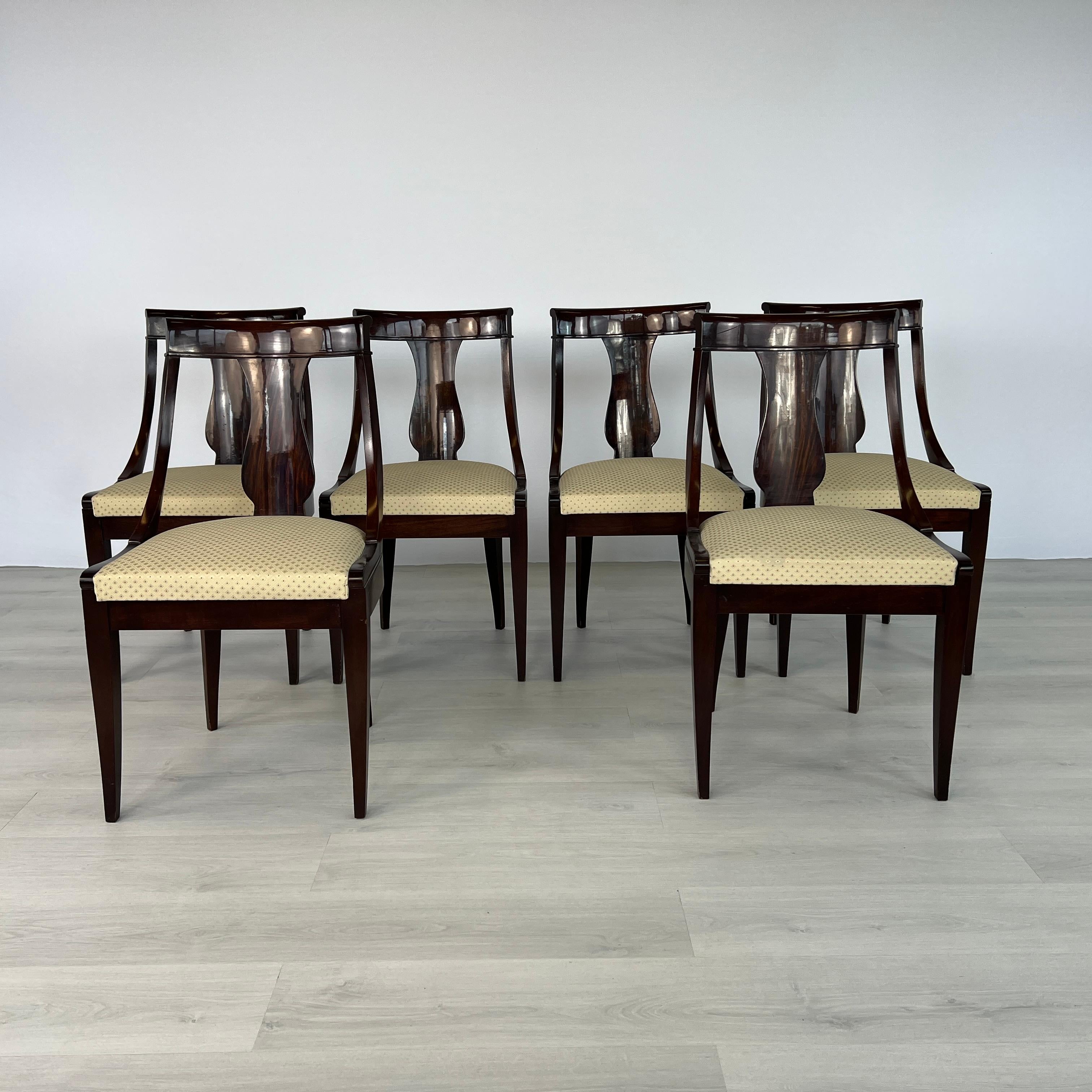 Dimensions: H 35” x W 19.5” x D 17.5” x SH 19”

Set of 6 Vintage Empire Gondola style dining chairs. Features solid mahogany construction with curved slat back and seats with original beige fabric.
Please see our other listings for ideas and