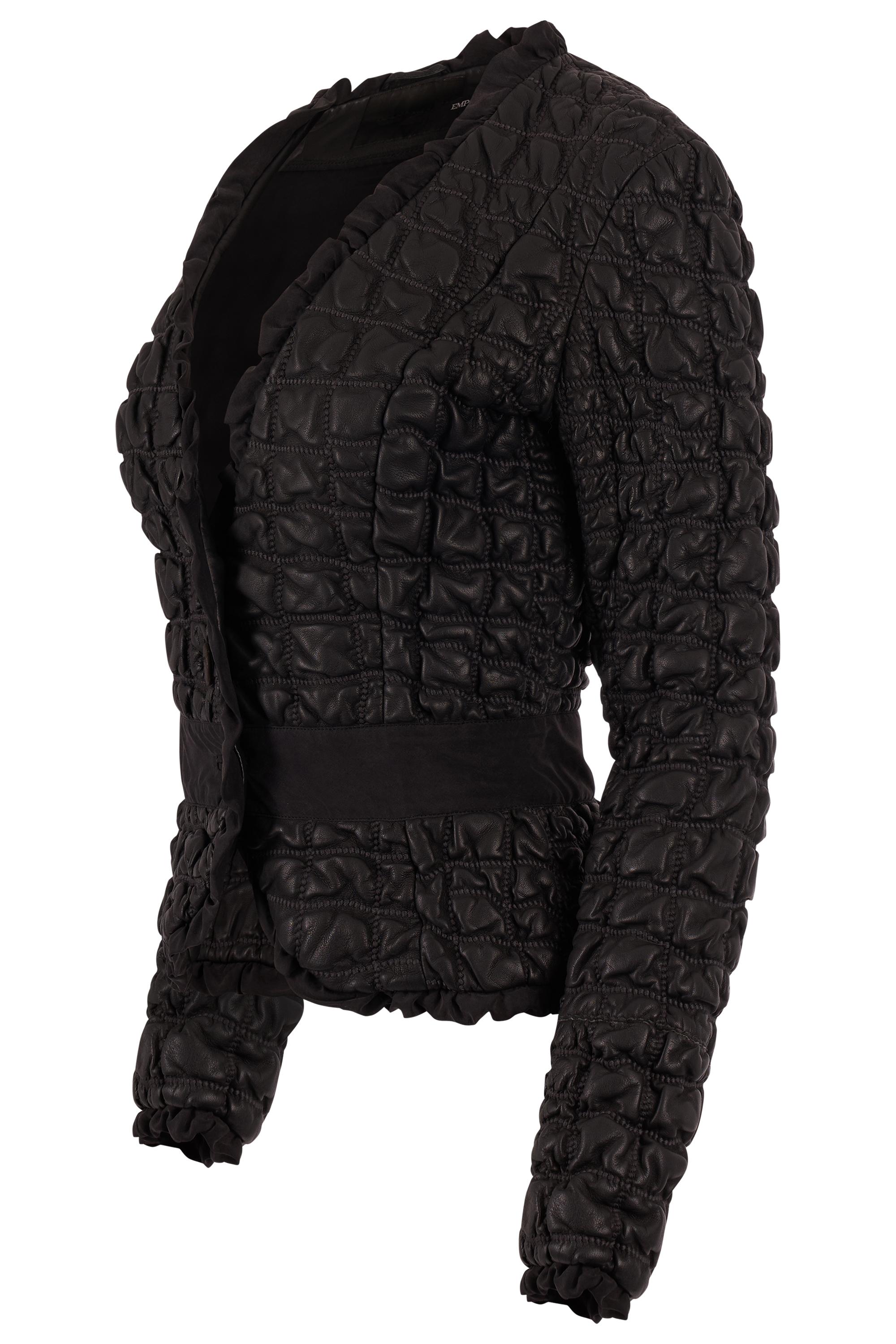 Vintage  Emporio Armani Fall Winter 2005 leather blazer. Features a supple black leather with a unique quilted finish  The fitted cut is accentuated by a cinched waist and soft peplum shape, ruffled trim along the lapels and hemline. Fastens with